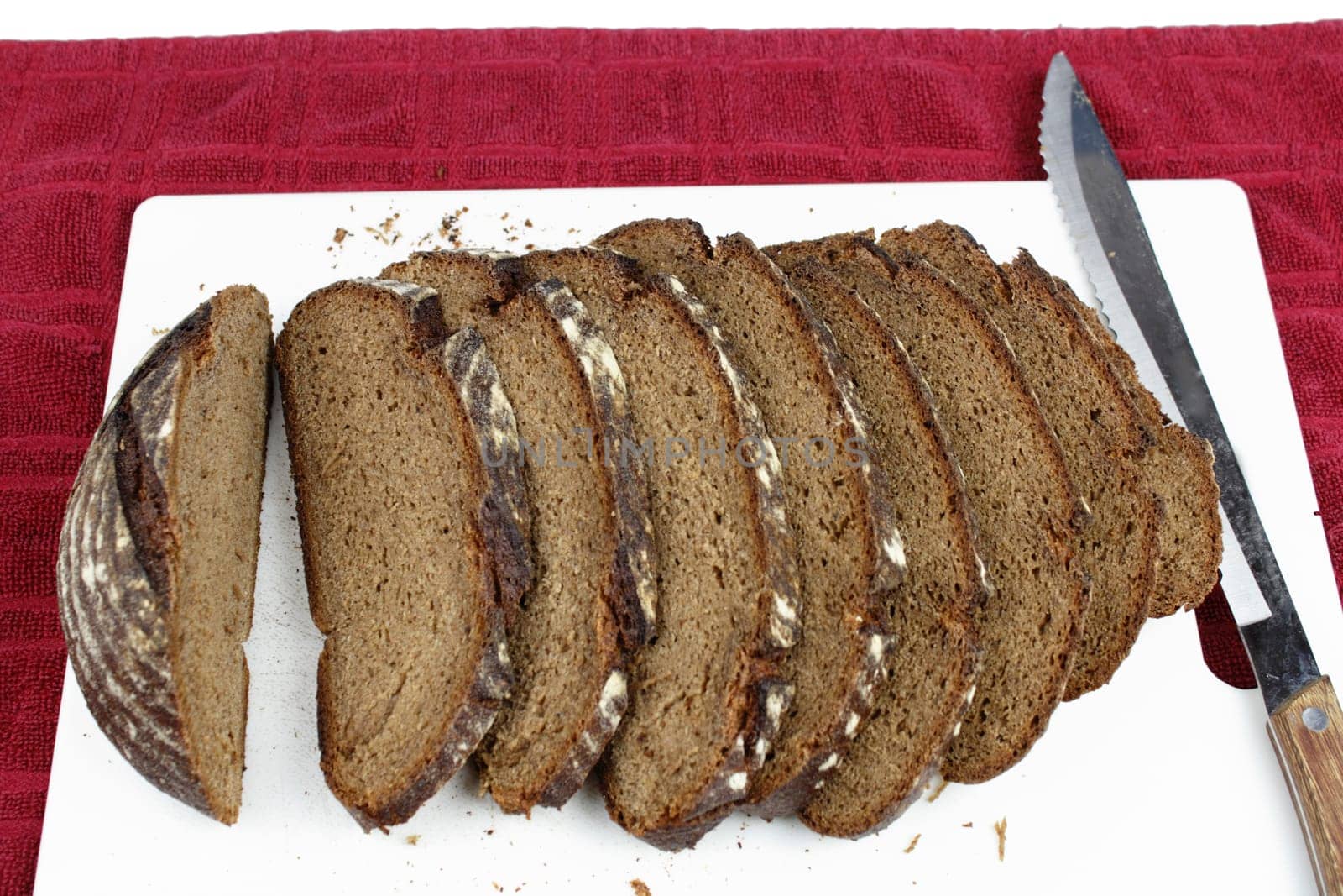 Several pieces are cut from a loaf on a cutting board.