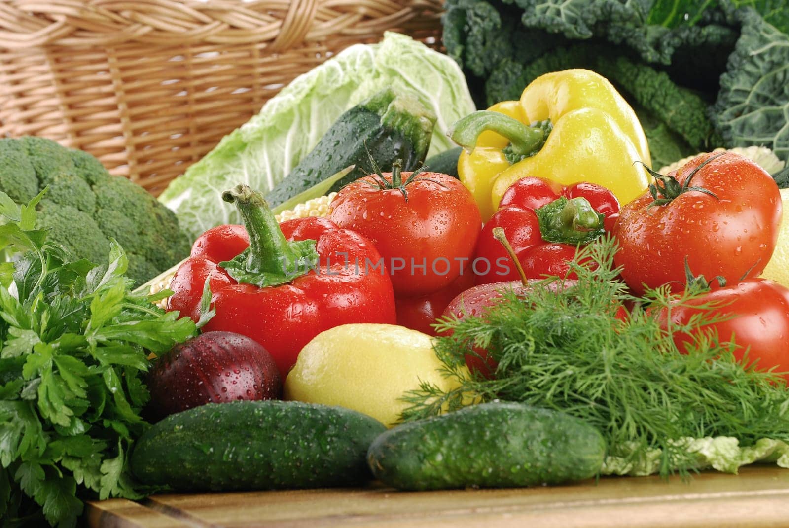 Composition with raw vegetables and wicker basket