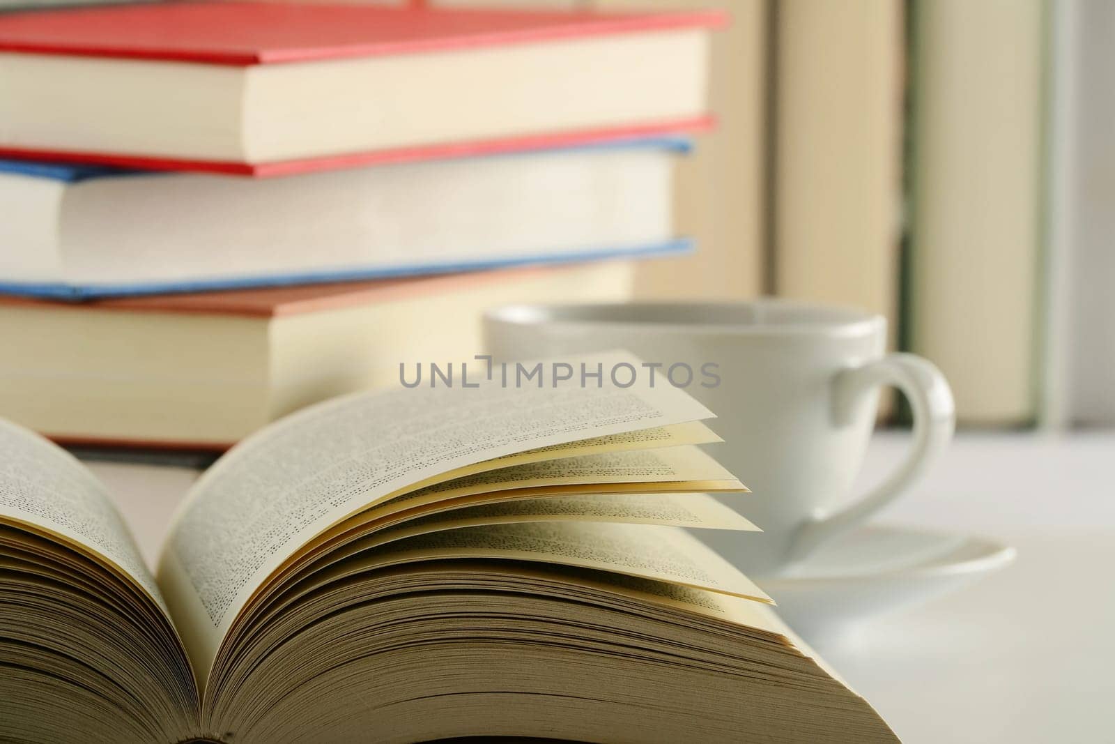 Composition with books and cup of coffee on the table
