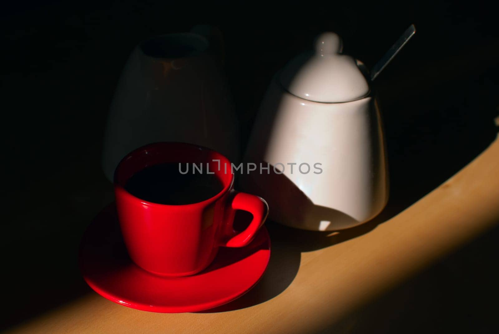 Espresso Coffee in Red Mugs, Cream Pot and Sugar Basin in Beam of Light