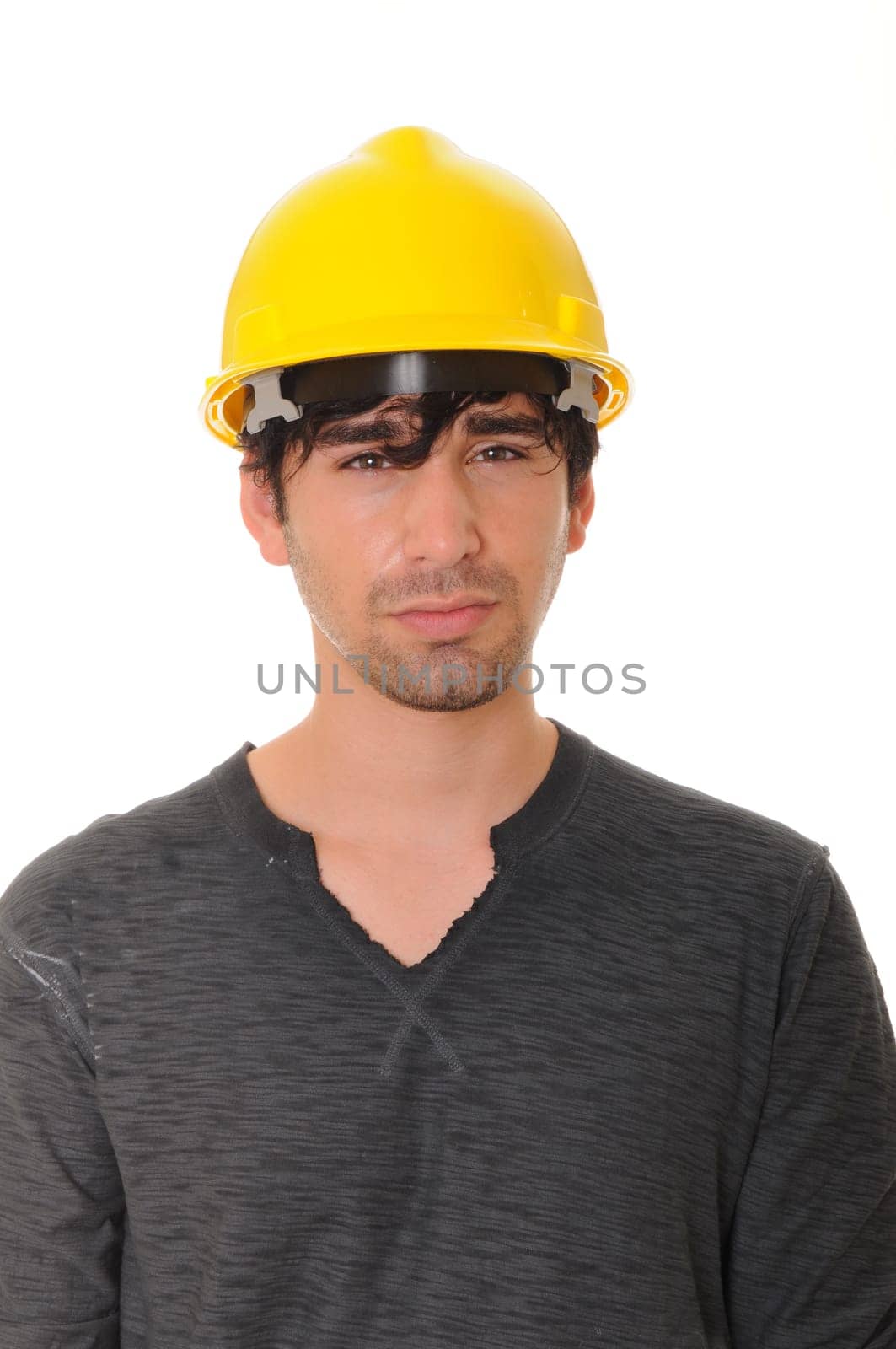 Young construction worker wearing a yellow hard hat isolated over white
