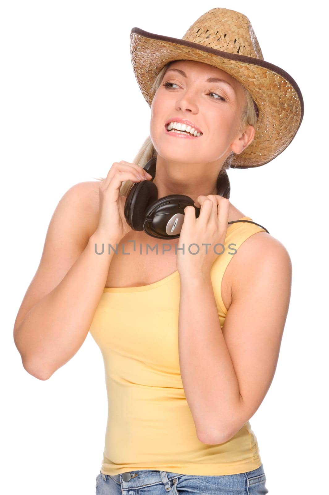 Studio shot of a young woman wearing a straw hat and headphones