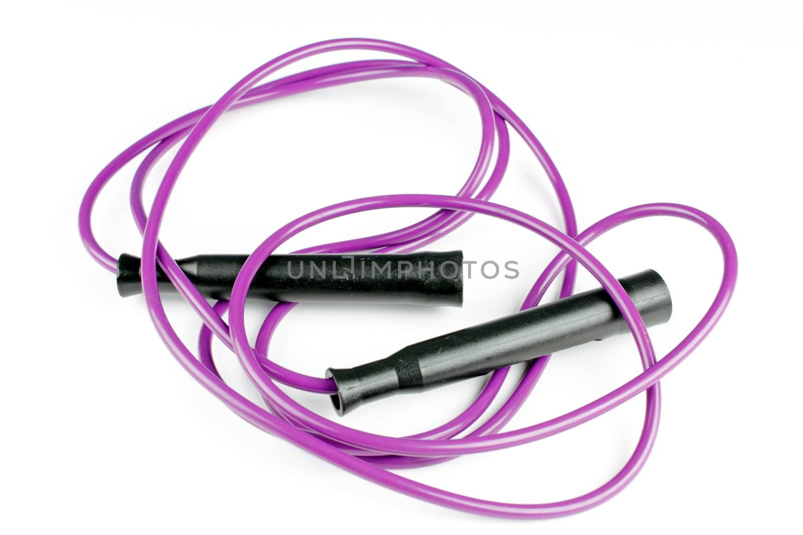 Purple jump rope tossed onto a white background after exercising.