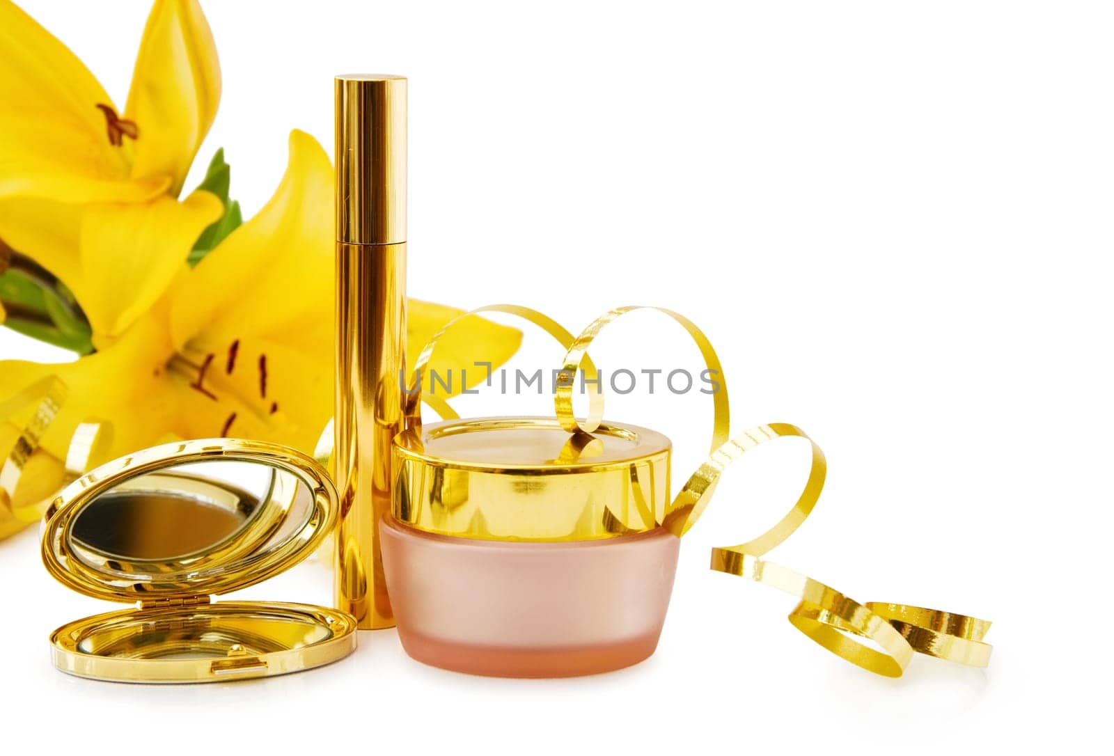 Luxury makeup set and face cream with festive golden ribbons. Perfect gift for a special day. Isolated on white background