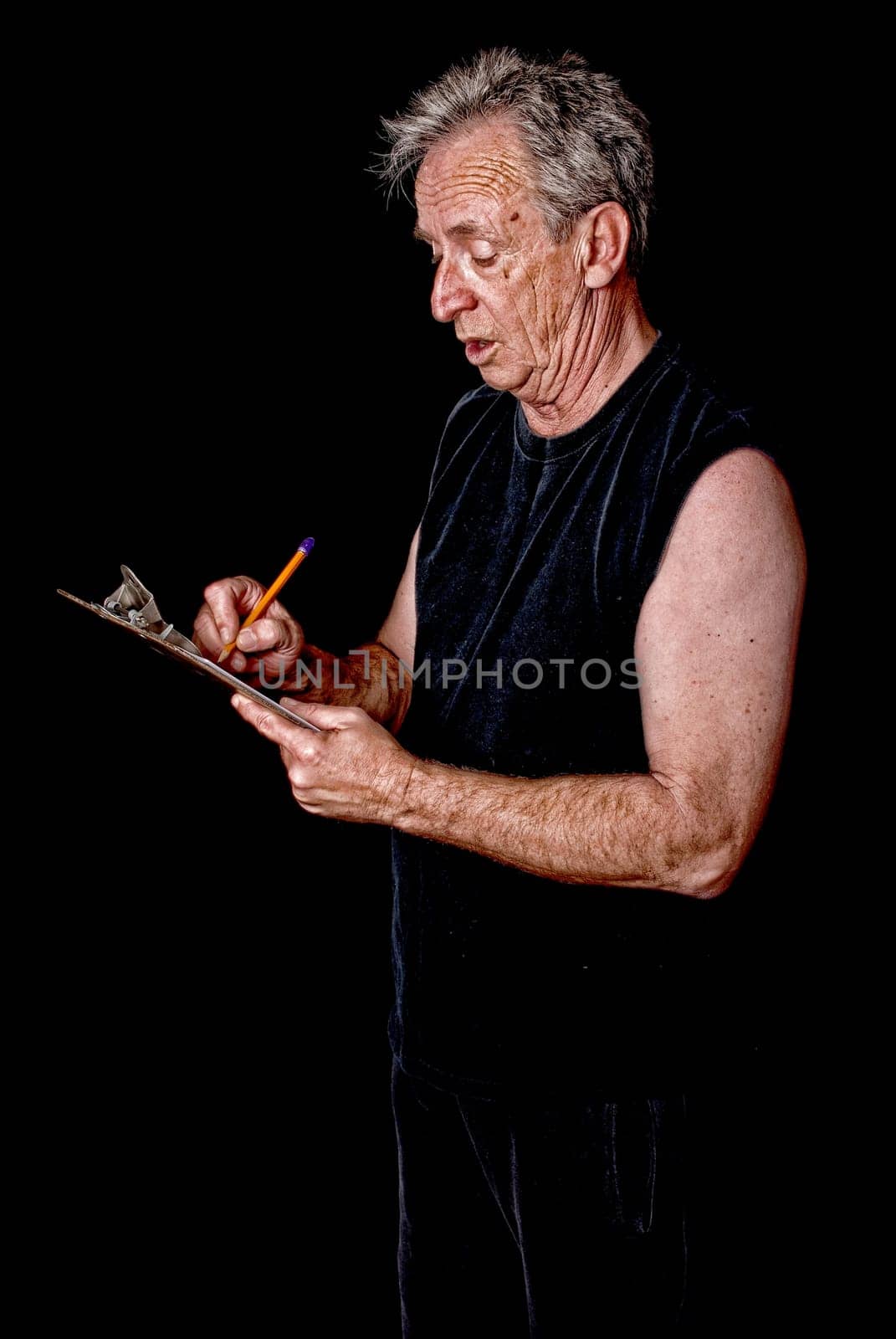 Senior citizen fitness trainer writing on a clipboard