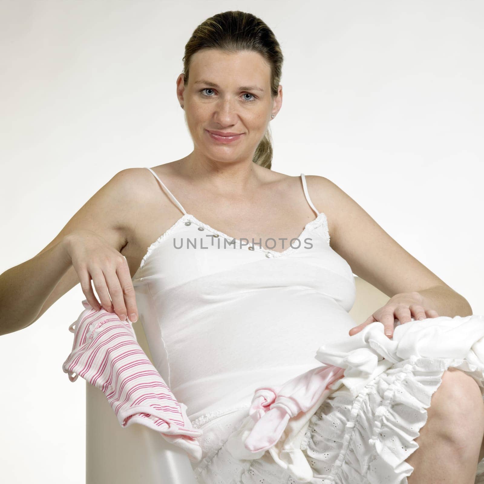 pregnat woman with clothes for babies