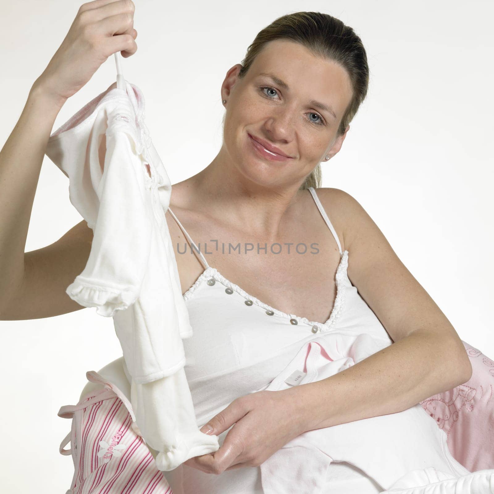 pregnat woman with clothes for babies