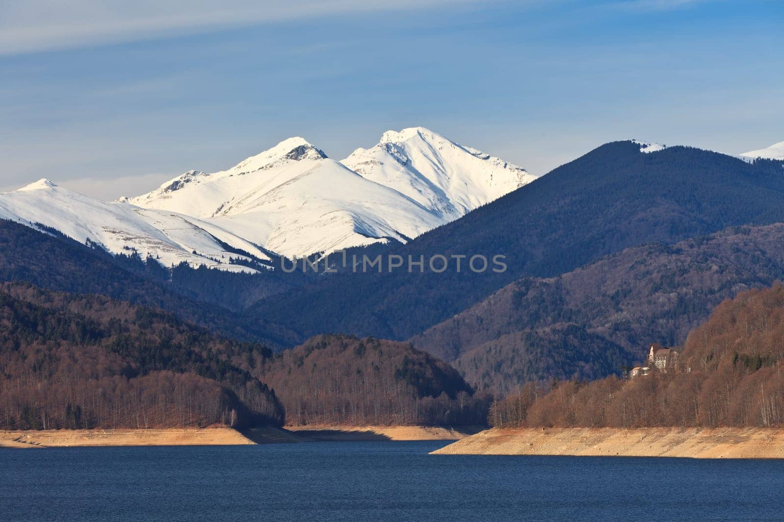 a mountain lake and mountain snow in the background