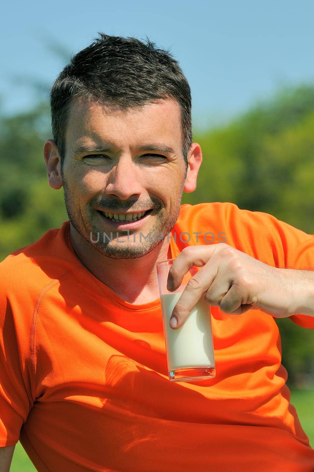 man is drinking fresh glass of milk in the natural background