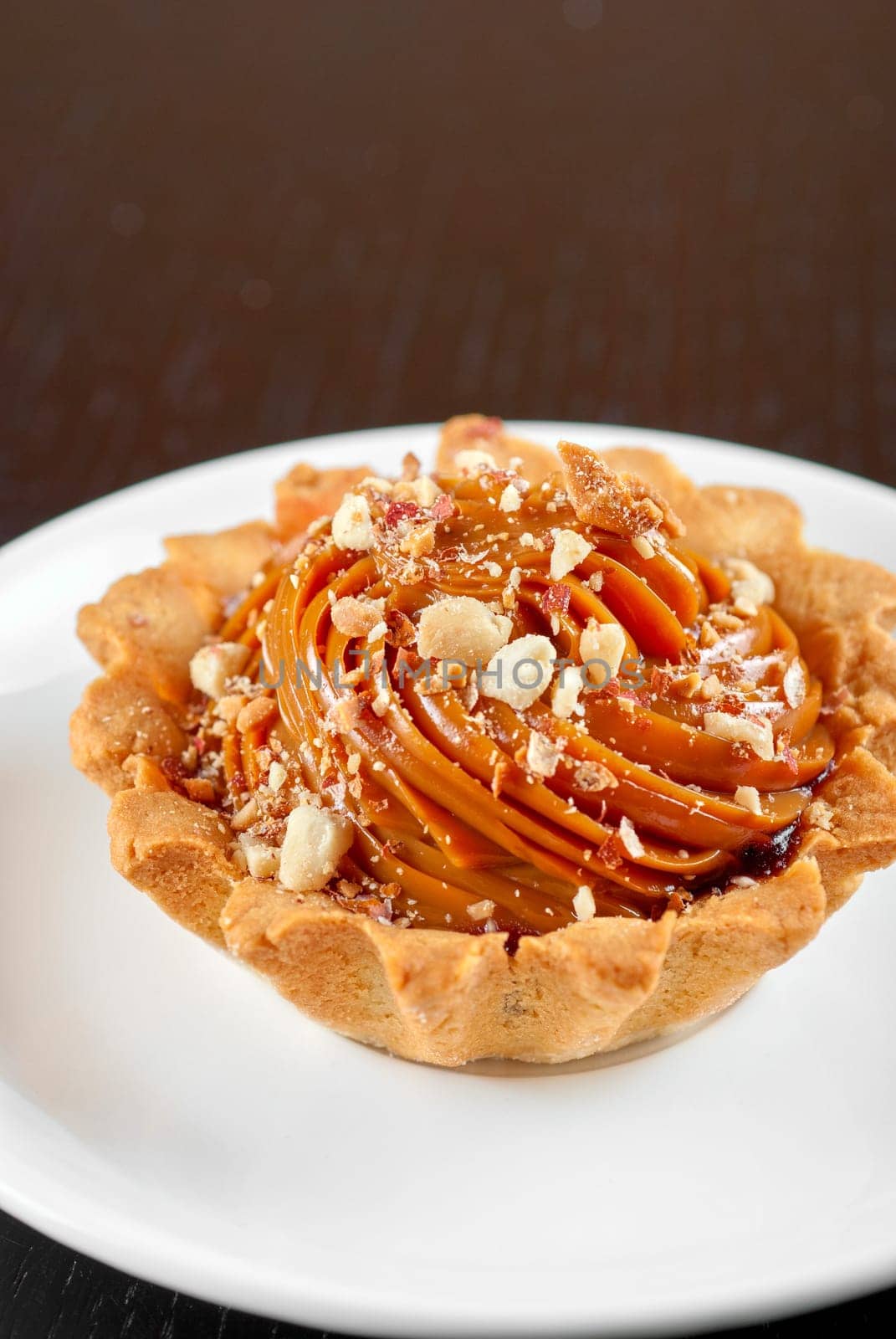 fresh baked cupcake with nuts on a wooden table