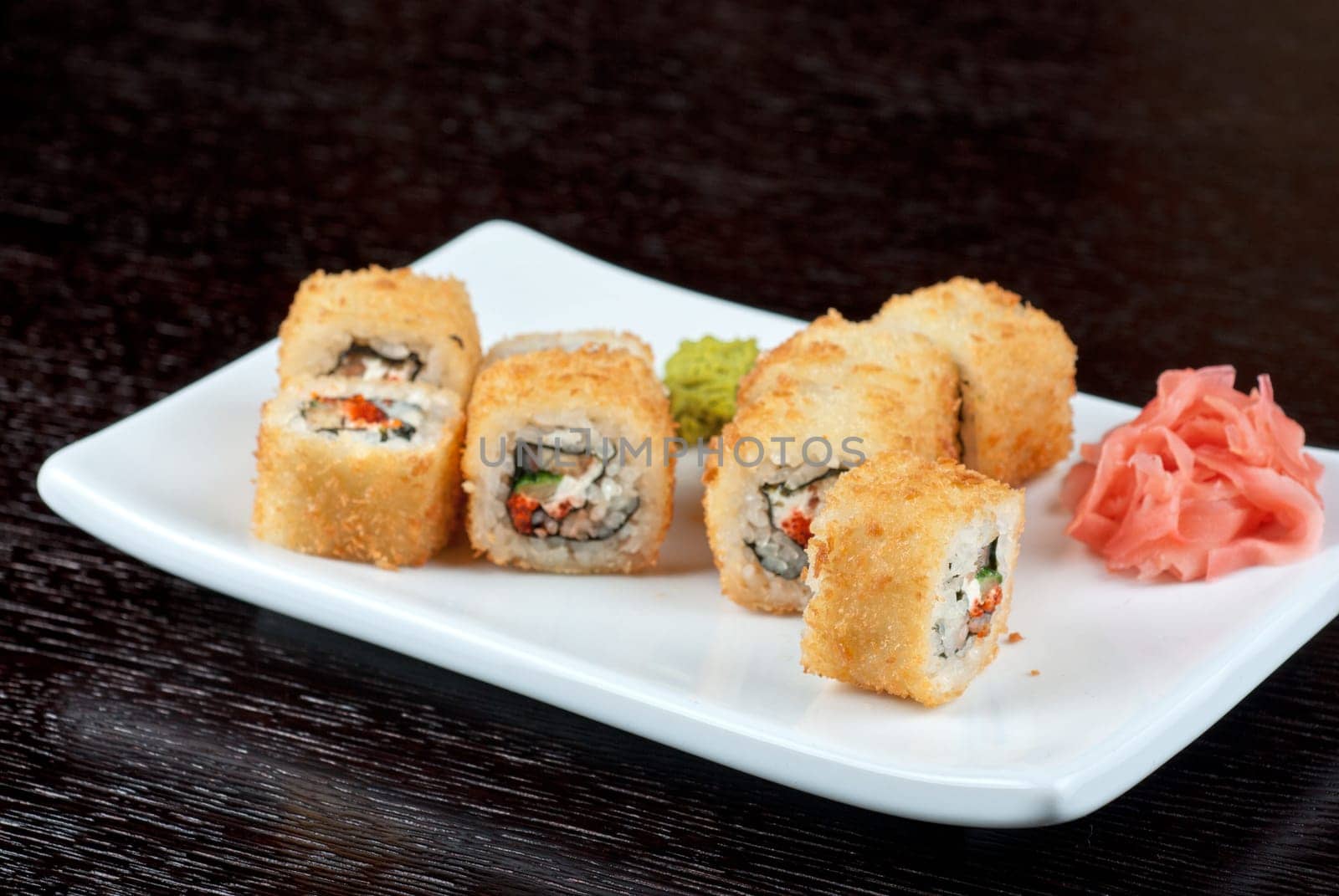Sushi rolls made of rice, smoked eel, cream cheese and flying fish roe - tobiko caviar