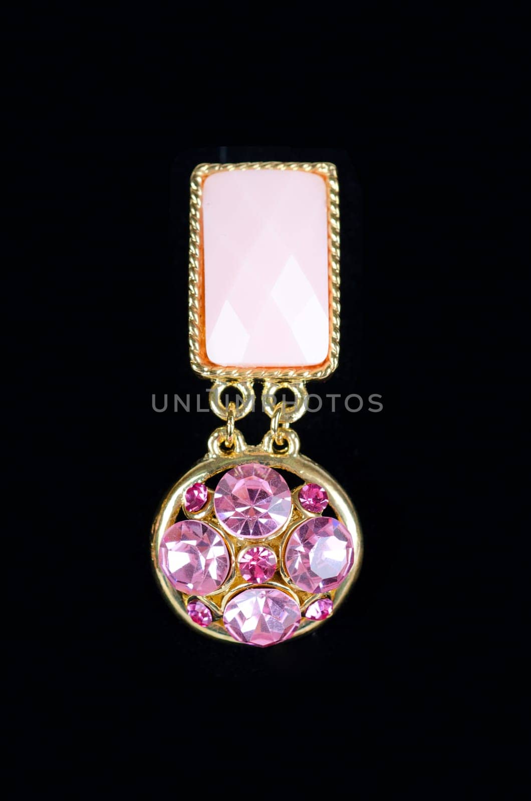 Beautiful earring with colorful red gems on black background
