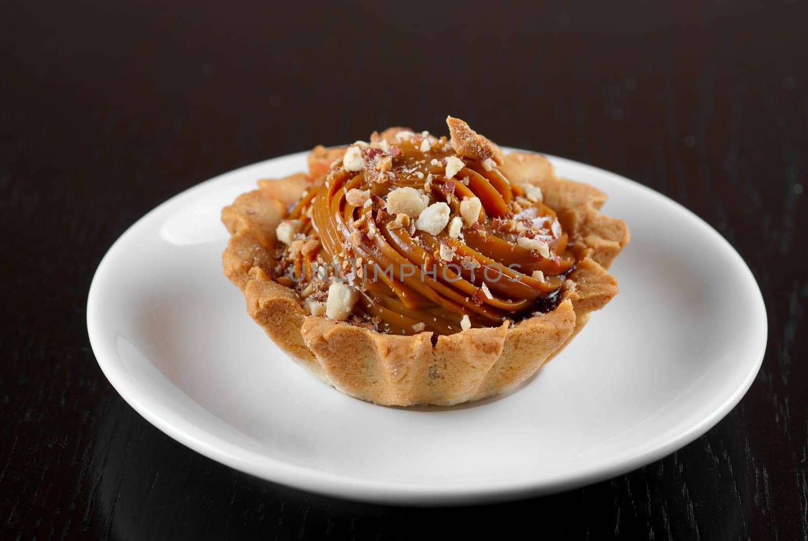 fresh baked cupcake with nuts on a wooden table
