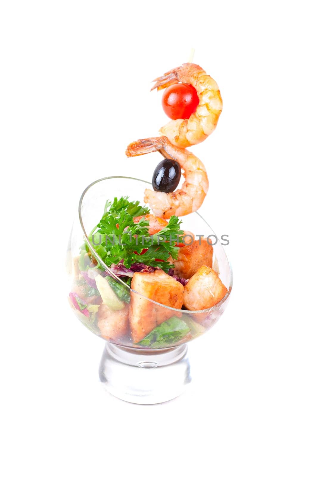 Fried kebab of shrimps with vegetables, greens and salmon fish