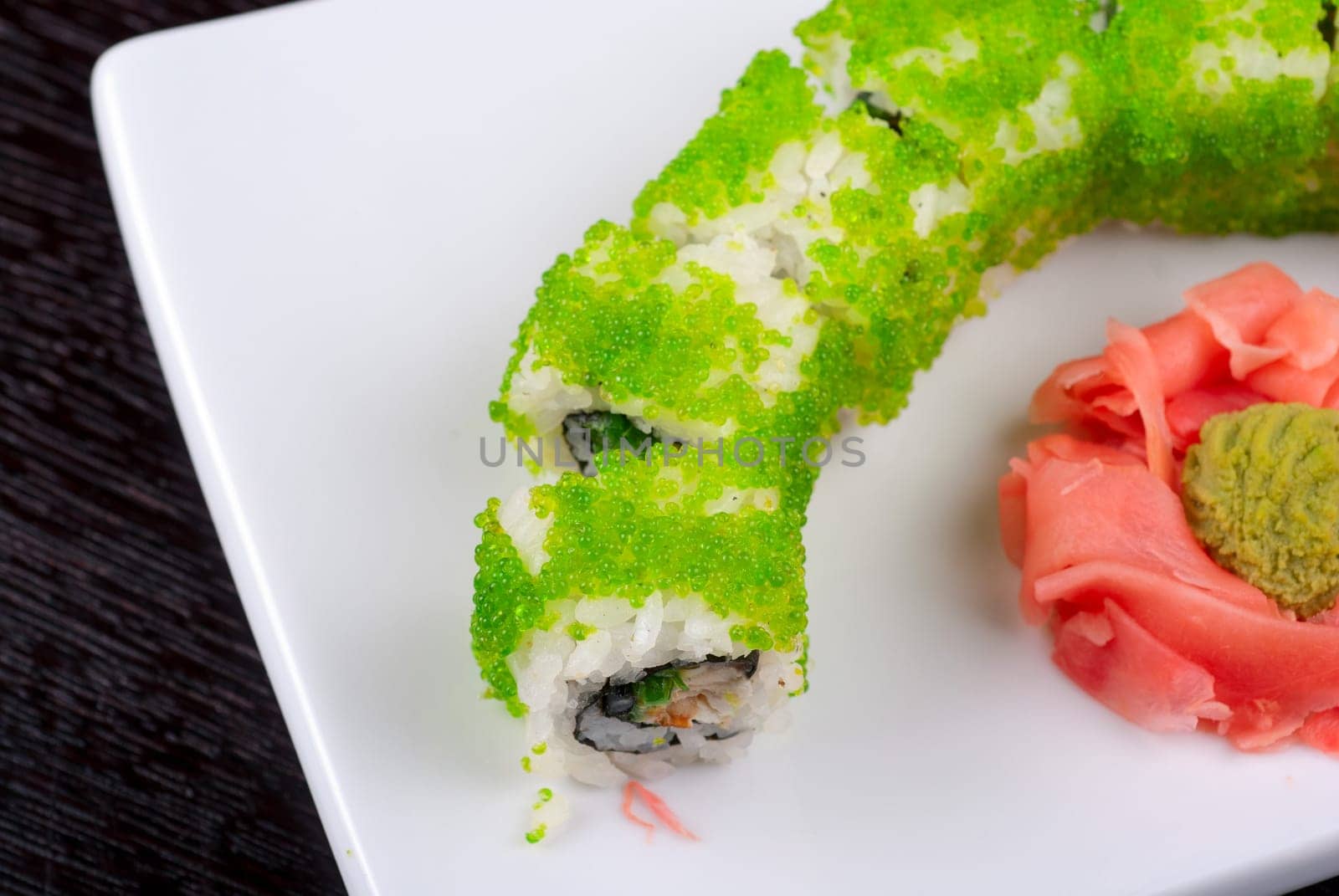 Sushi rolls made of salmon, avocado, flying fish roe - tobiko caviar and philadelphia cheese