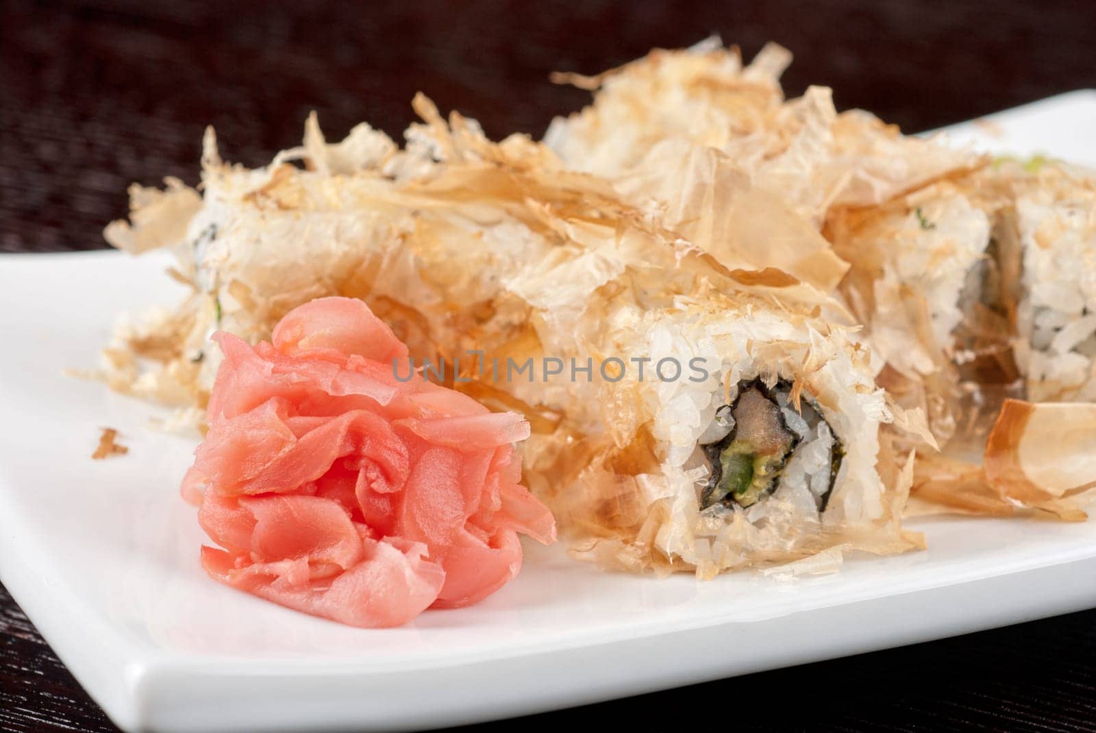Sushi rolls of rice, nori, cream cheese, avocado, smoked salmon,cucumber and cuts of tuna