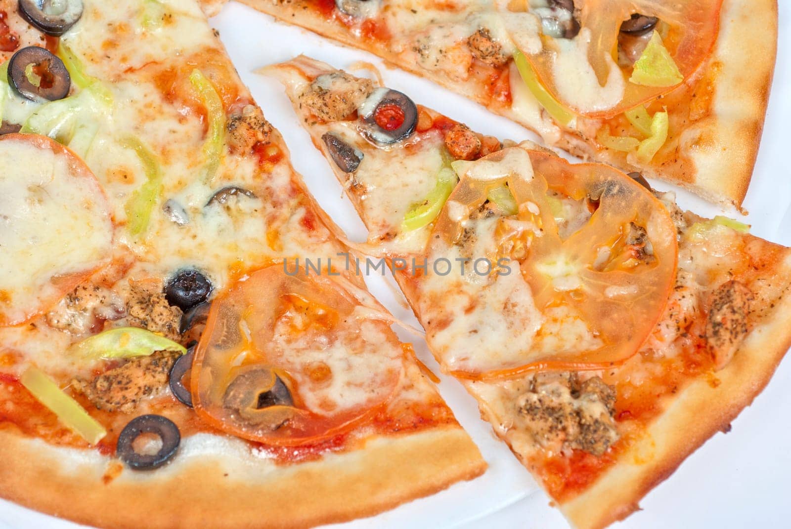seafood pizza closeup with salmon, shrimps, tomato, pepper, olive and mozzarella cheese on a white background