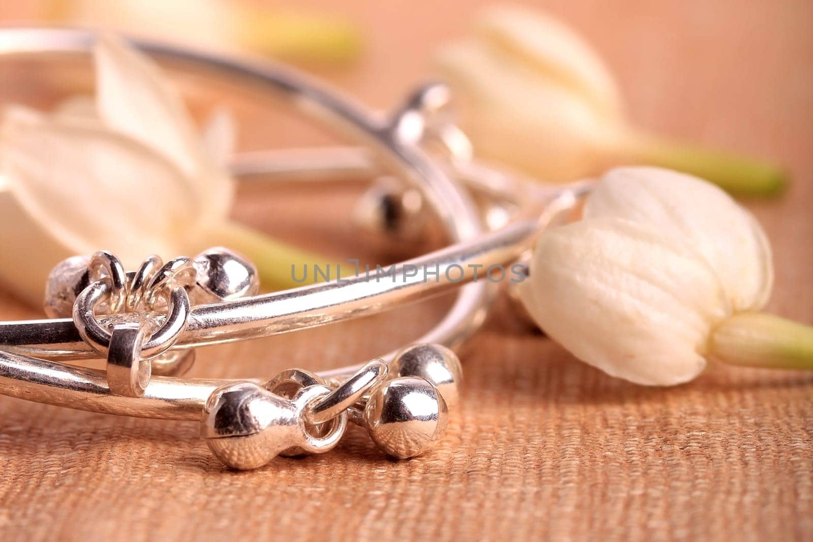 Child leg bracelet closeup with jasmine flowers