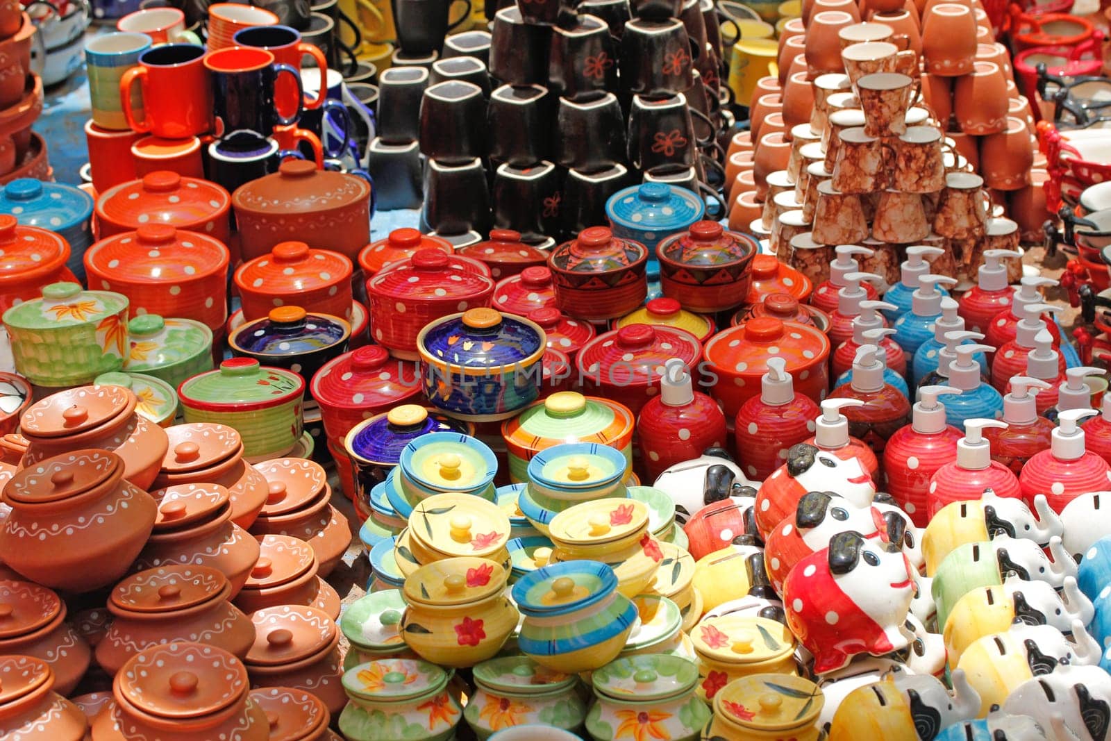 Colorful ceramic pots and utensils displayed for sale
