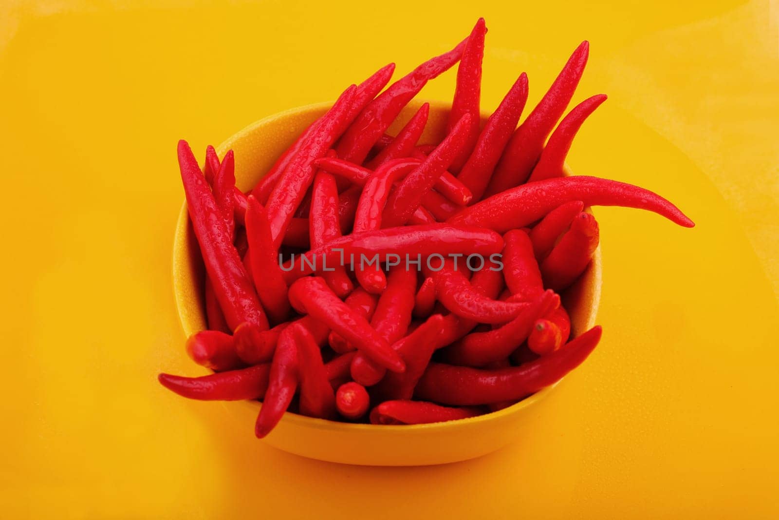 Bunch of cayenne peppers in a yellow bowl