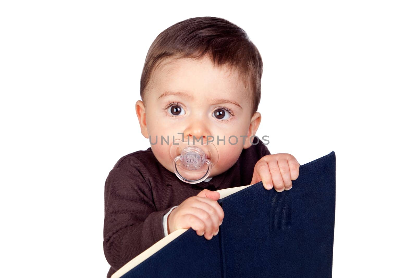 Beautiful baby with a pacifier reading isolated on white background