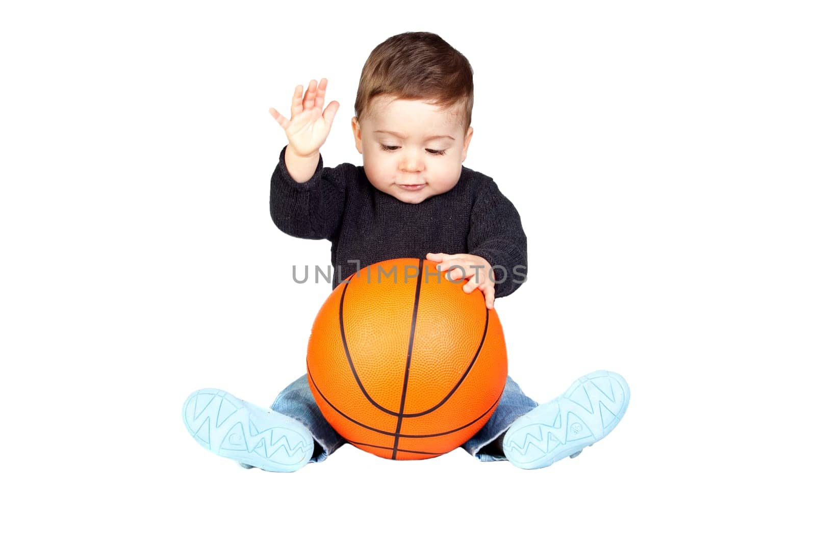 Beautiful baby with a basketball isolated on white background