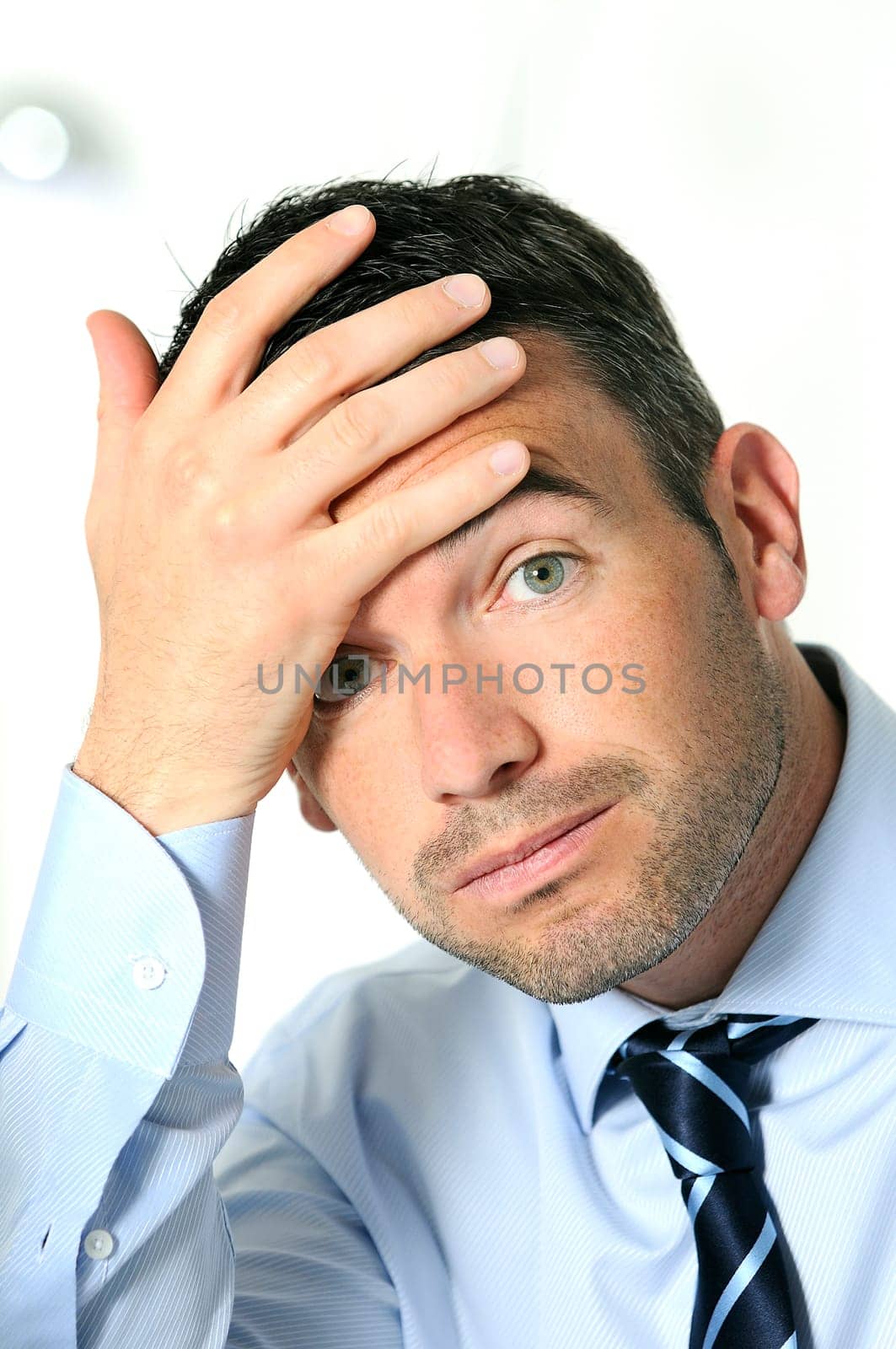 stressed overbooked and tired caucasian businessman