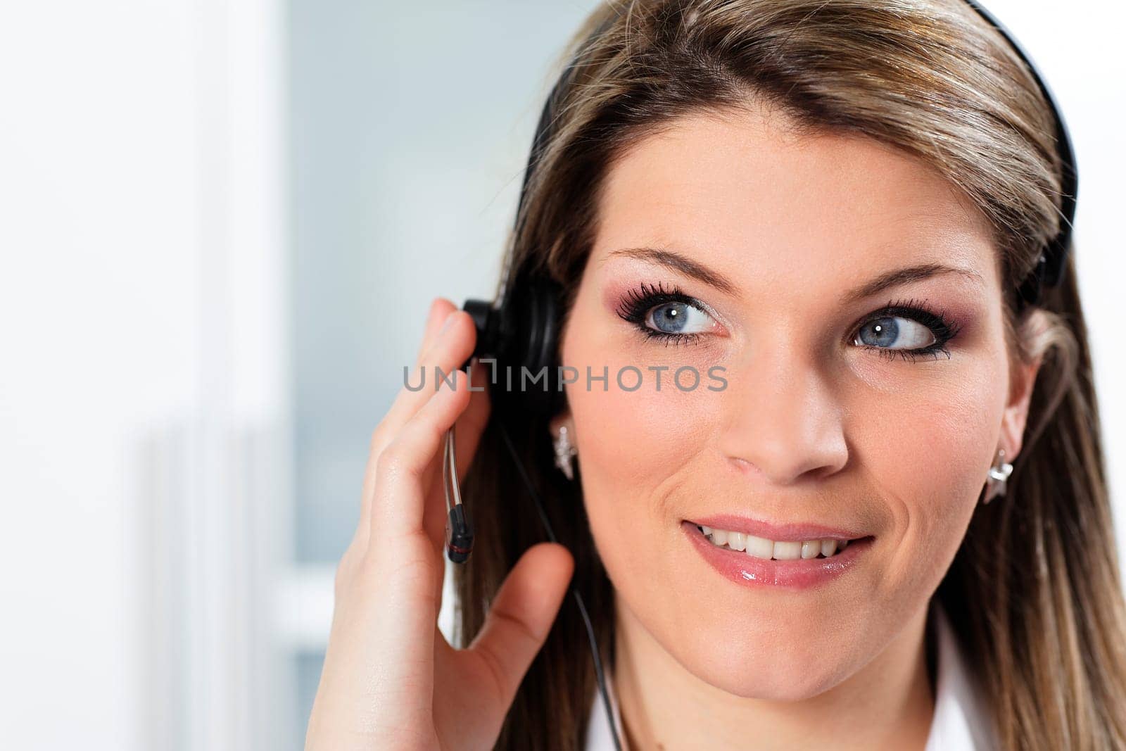 young beautiful woman with headset in office