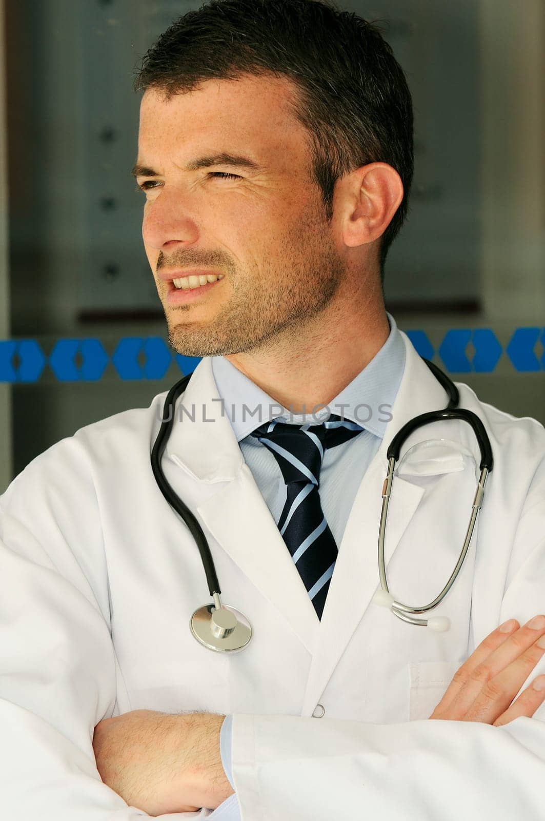 portrait of doctor in front an entrance of the hospital