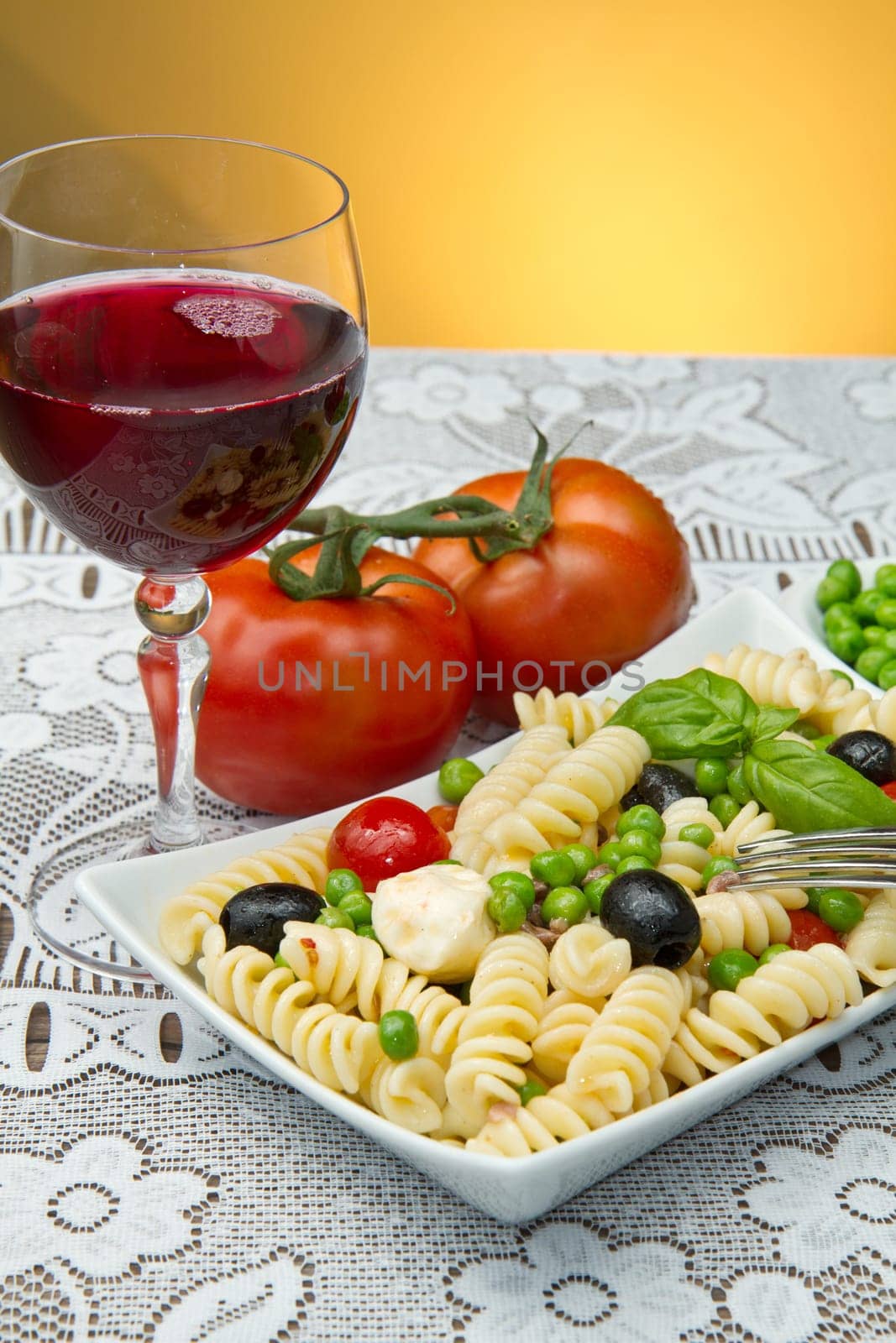 Pasta salad with mozzarella with a glass of red wine