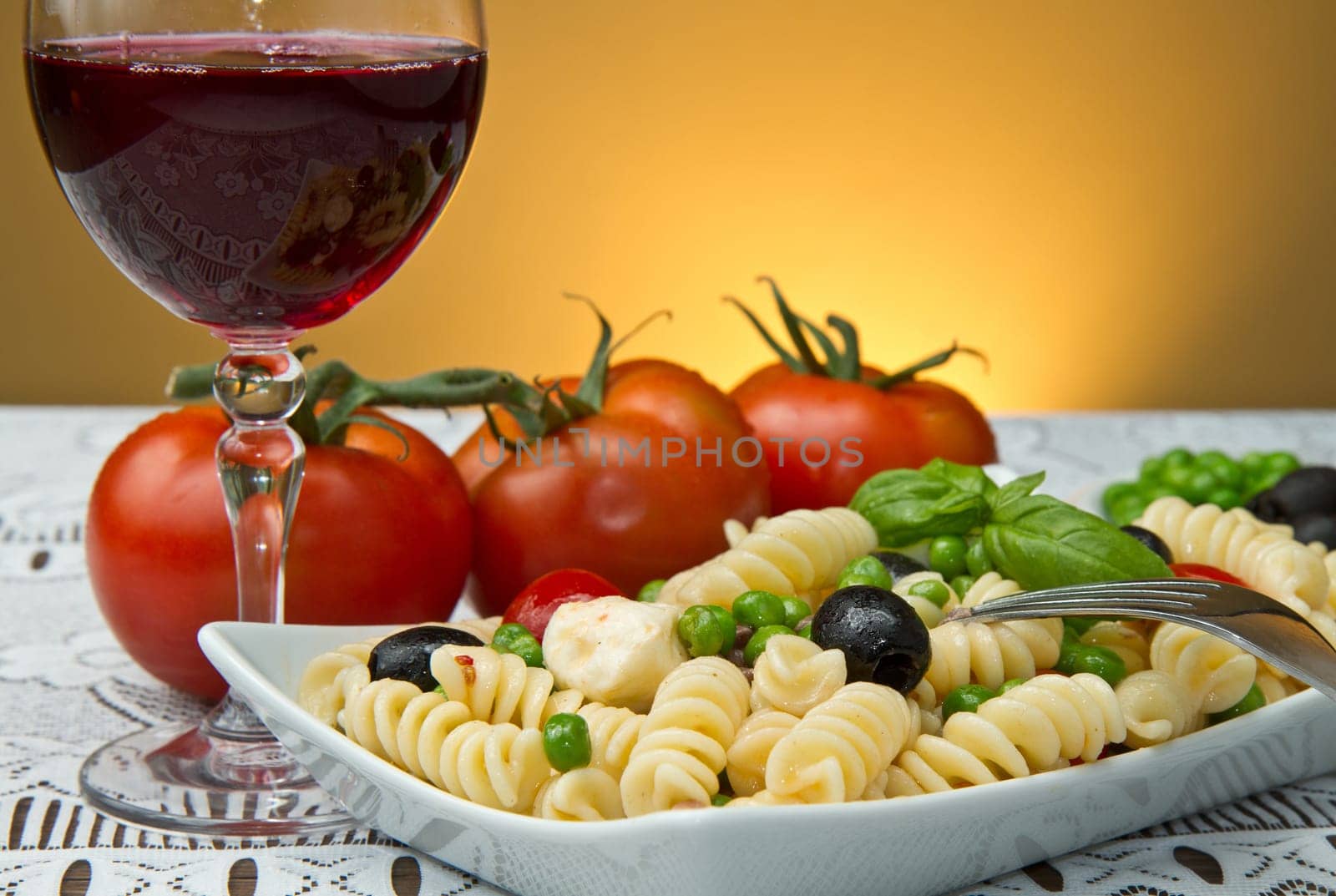Pasta salad with mozzarella with a glass of red wine