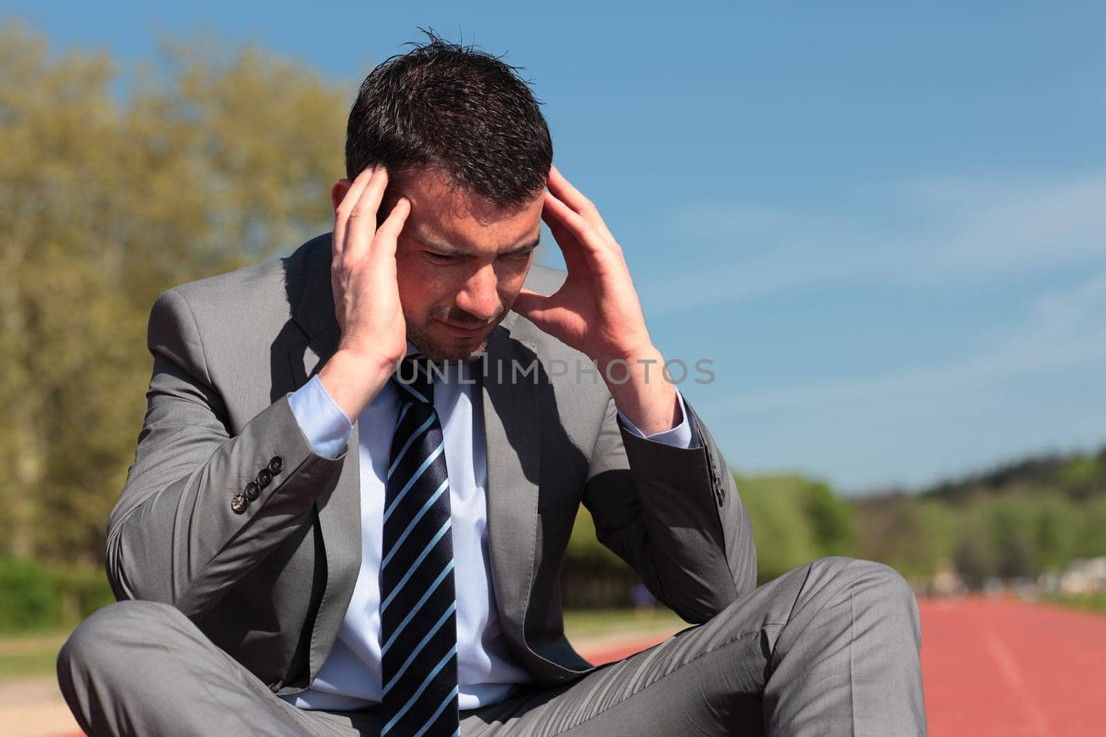 young businessman with head in the hands
