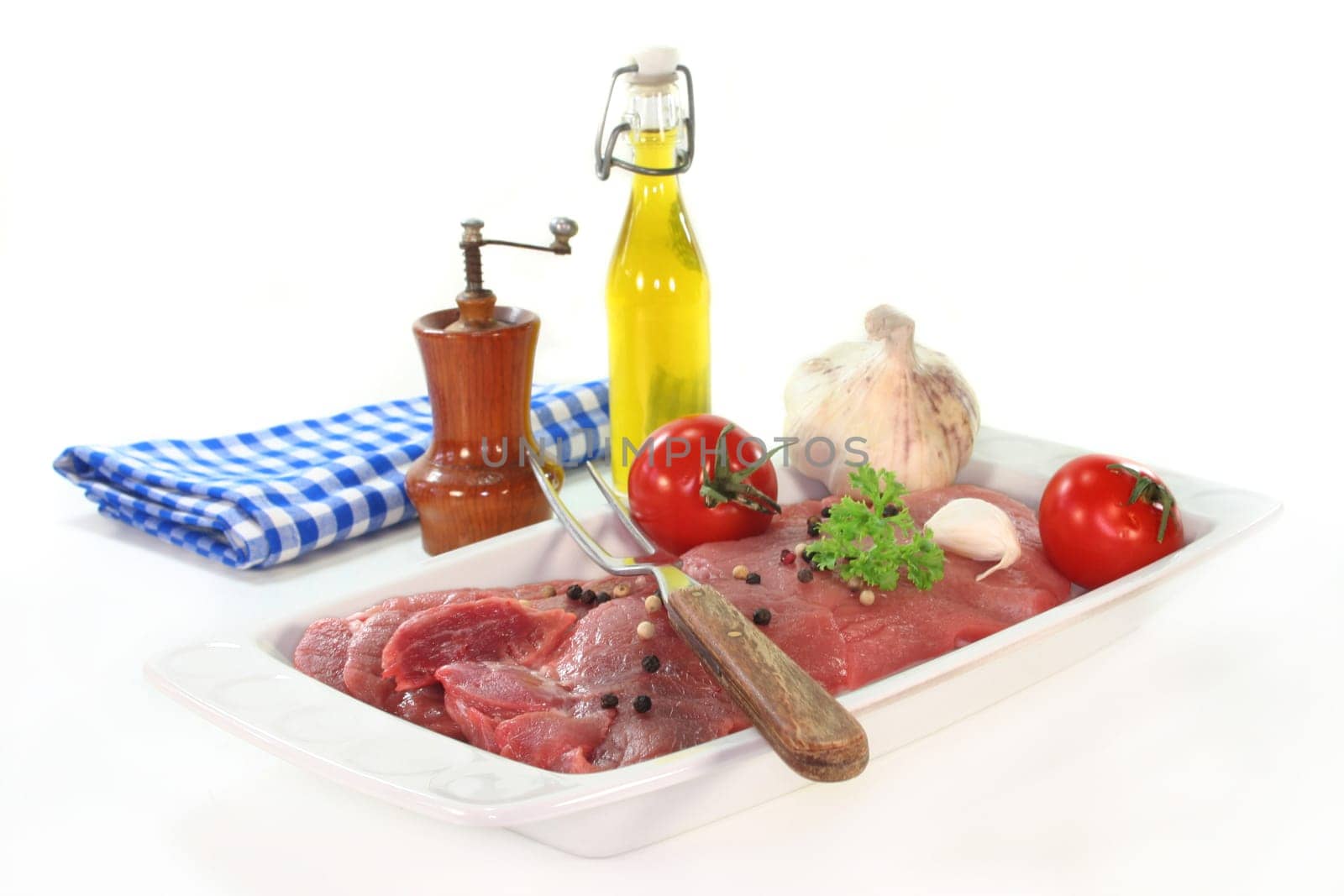 two raw pork steaks on a white serving platter