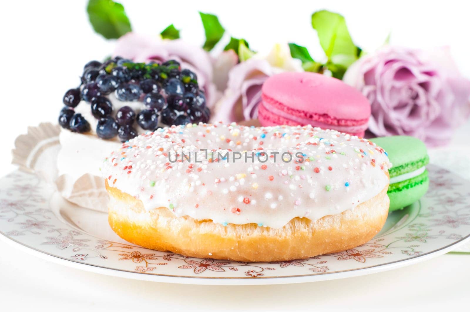 Sweets and roses in studio isolated on white