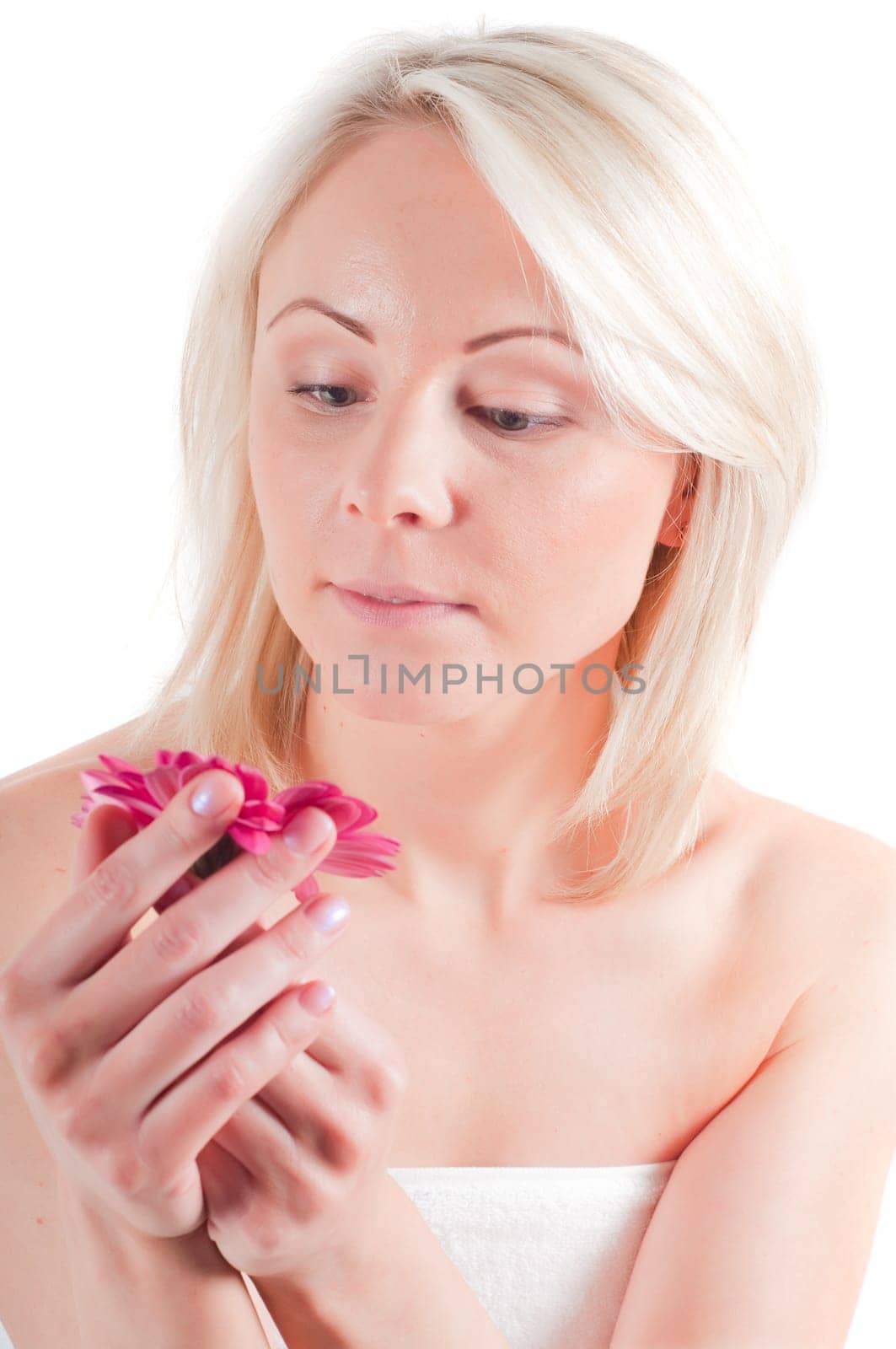 Shot of young woman holding gerbera on her palms