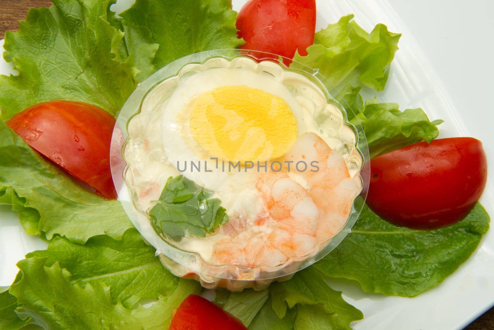 aspic with shrimps and eggs on fresh salad
