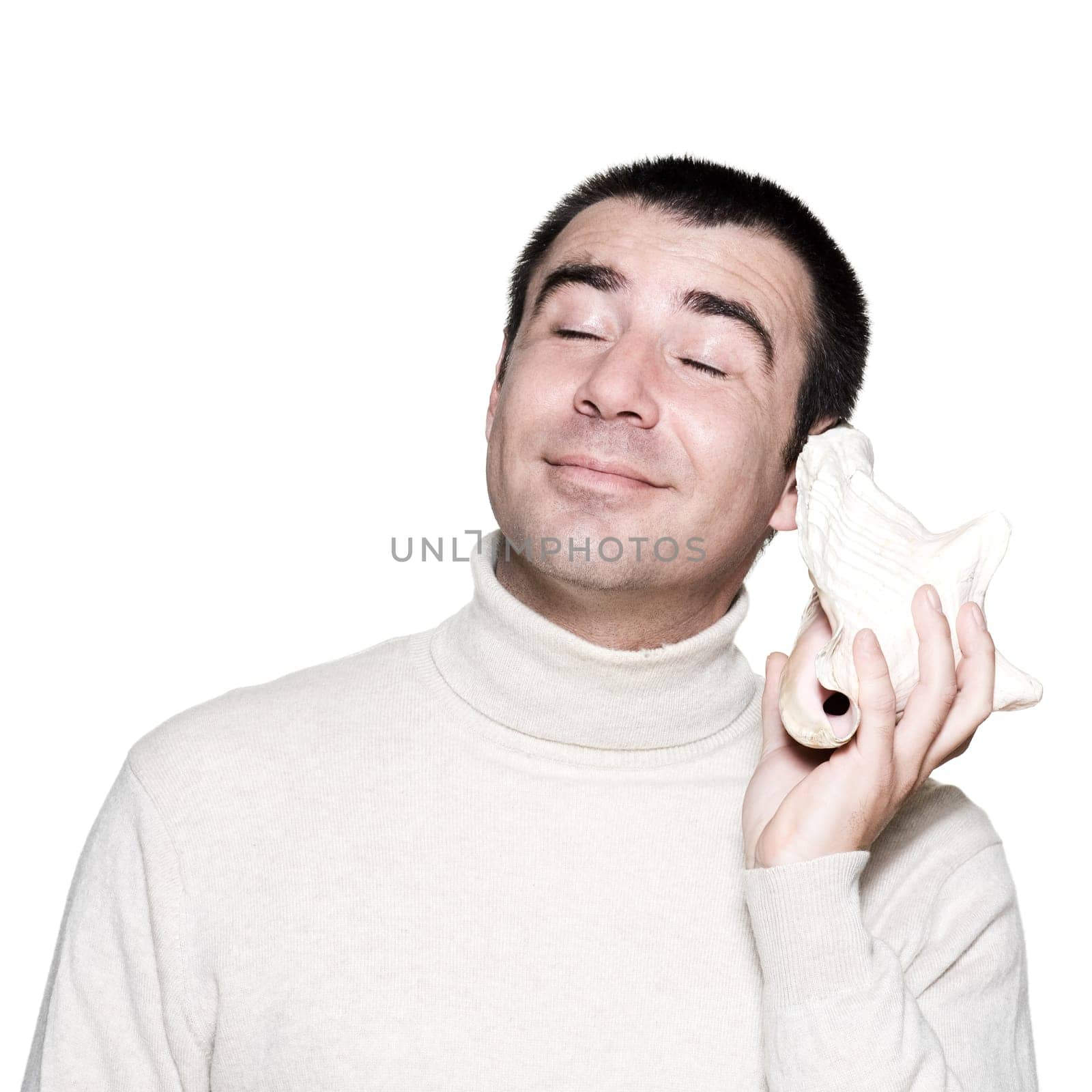 Expressive man enjoying seashell music with eyes closed on white isolated background