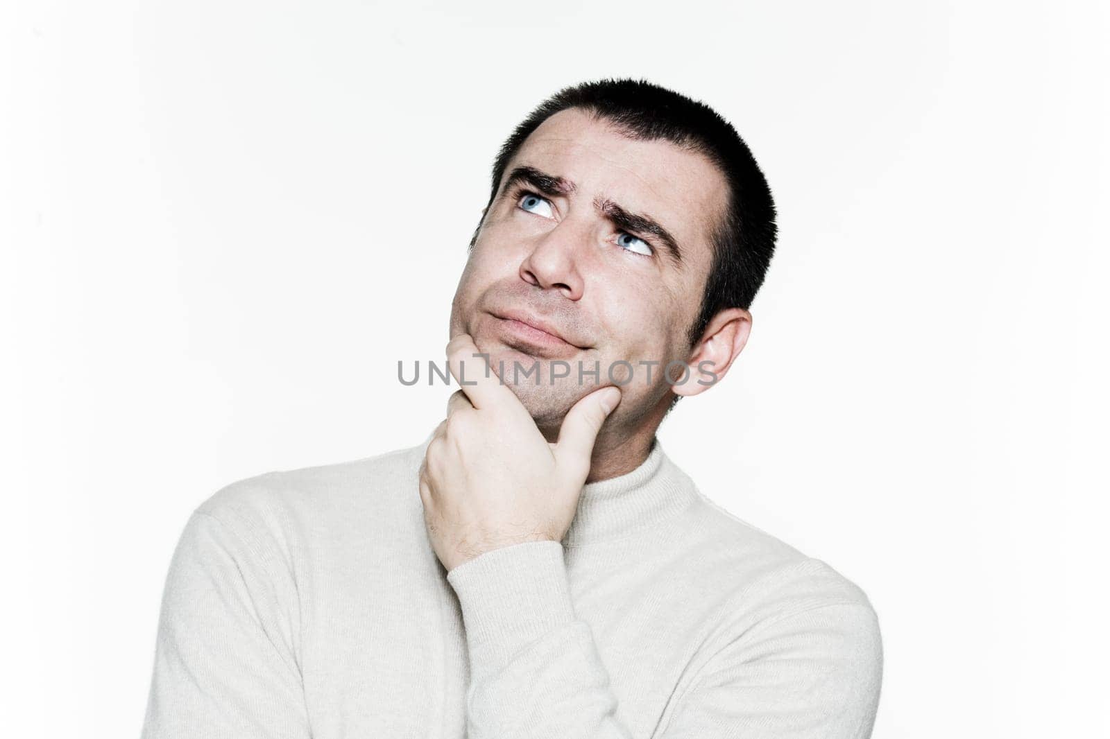 Portrait of a contemplative mature man looking up in studio on white isolated background