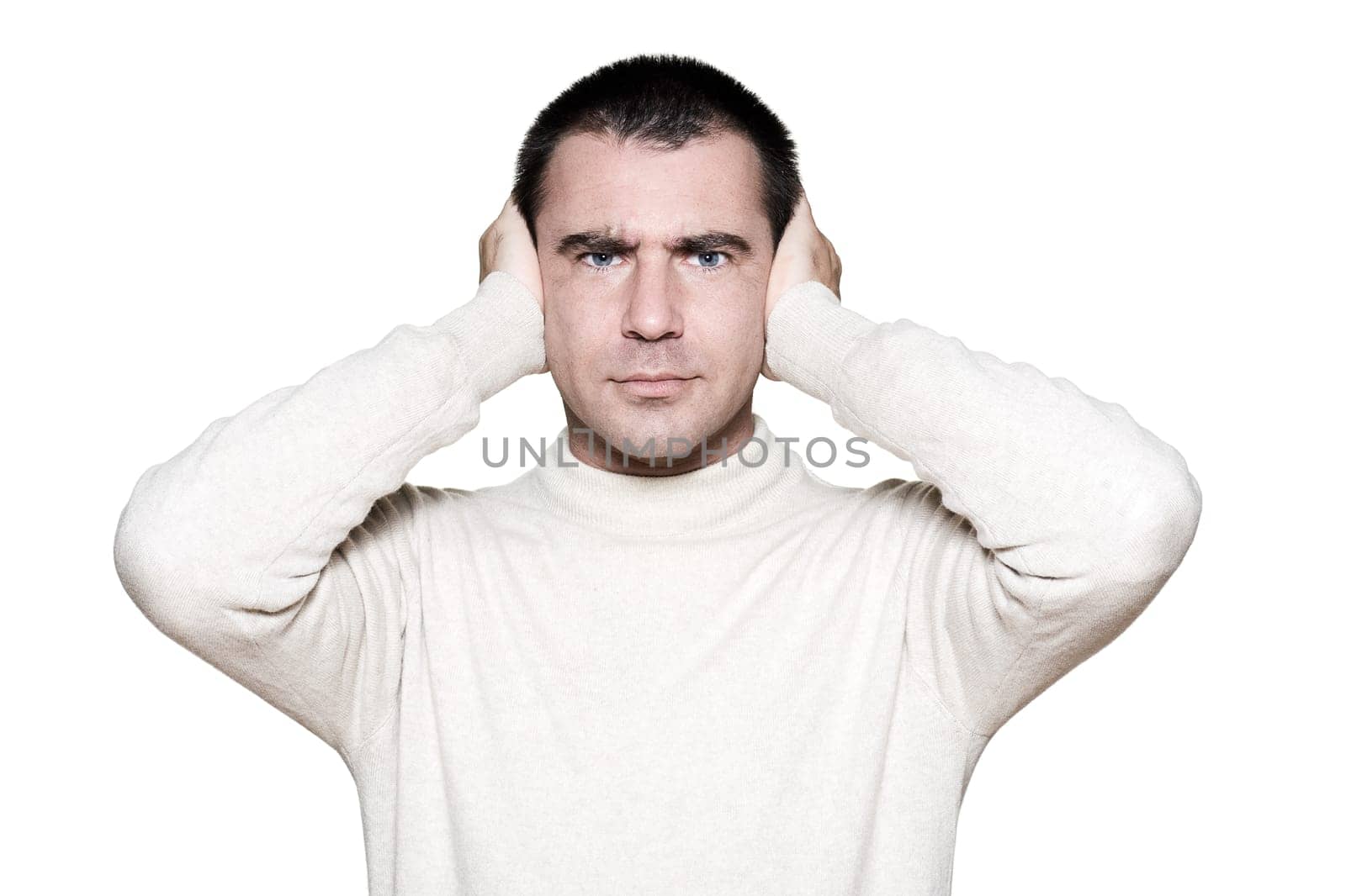 Portrait of a handsome expressive man covering his ears in studio on white isolated background