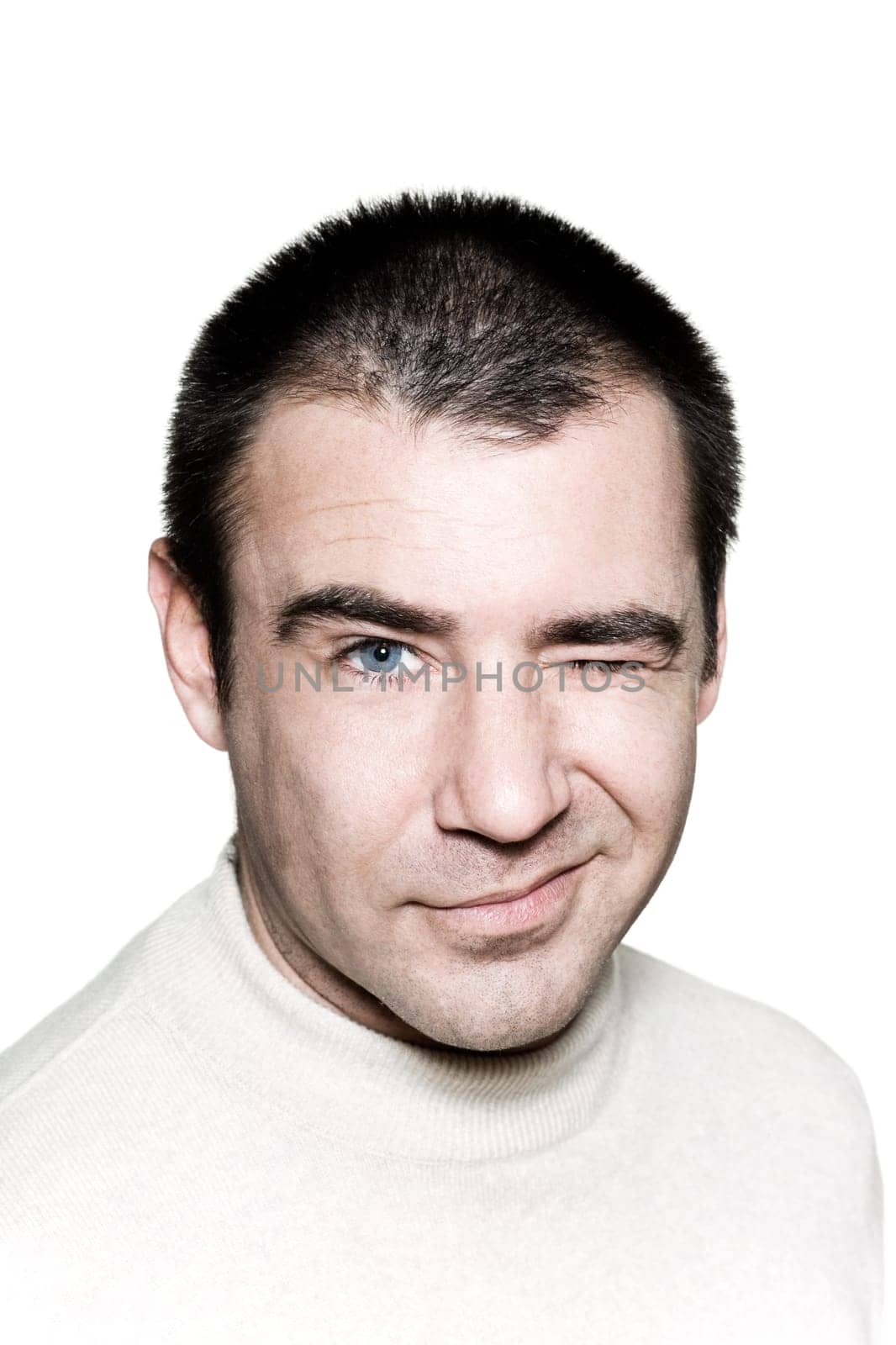 Portrait of a mischievous man winking on white isolated background