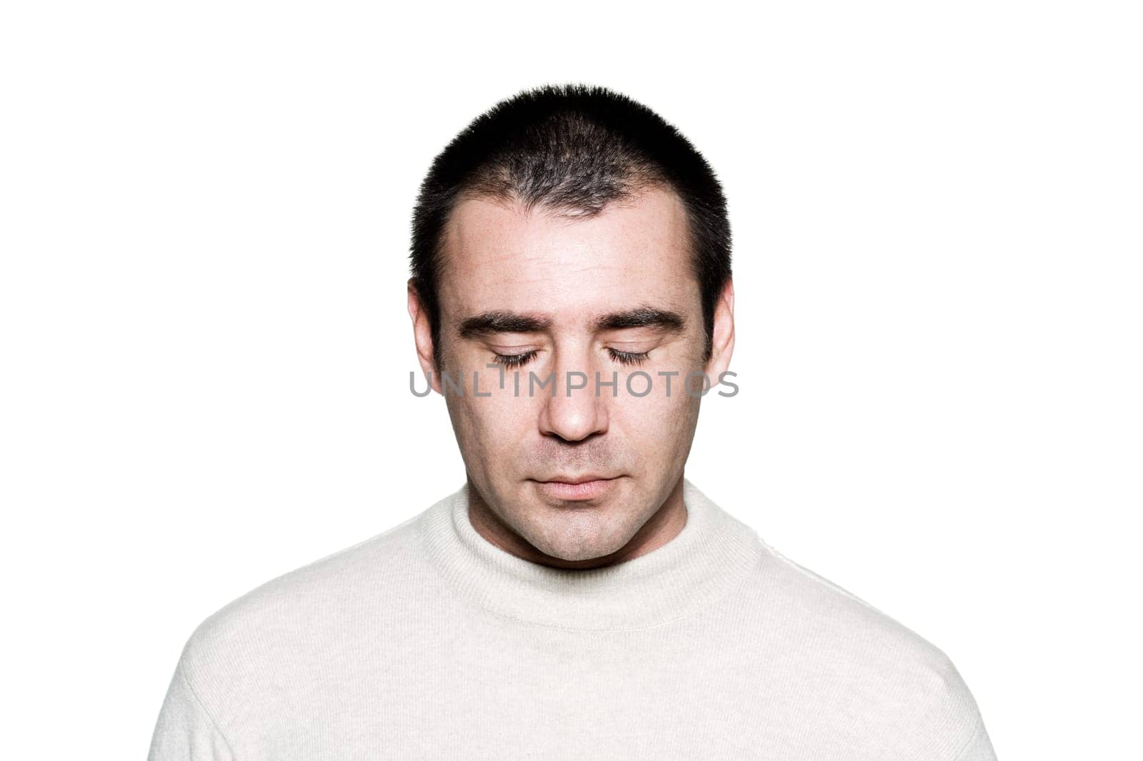 Portrait of a handsome expressive man meditating in studio on white isolated background