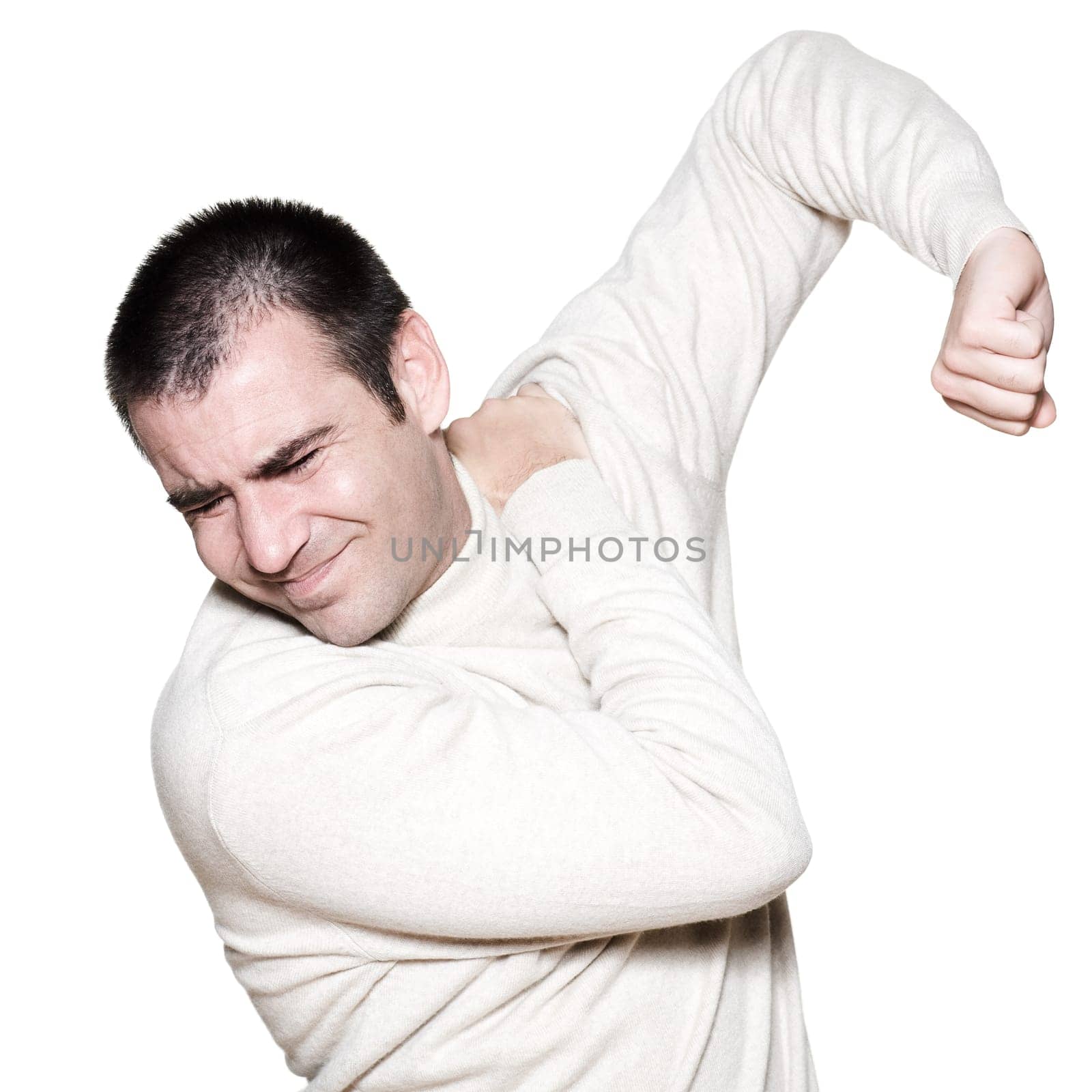 Portrait of a handsome expressive painful man holding shoulder on studio on white isolated background