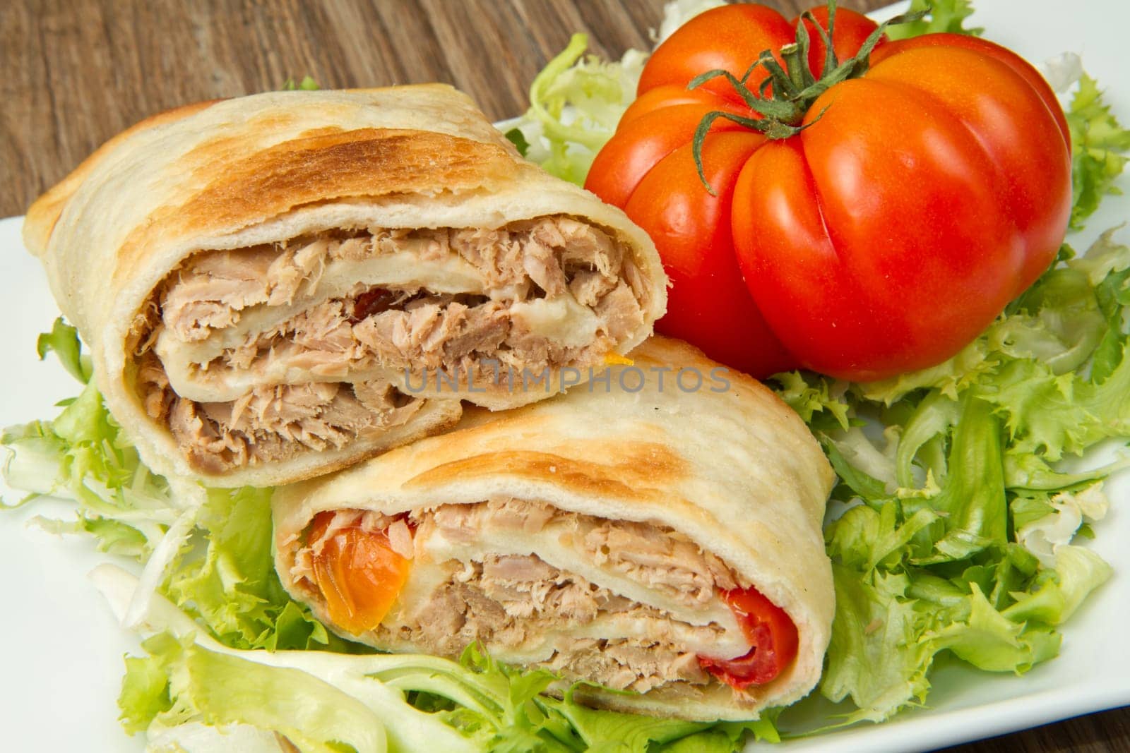 tuna sandwich on fresh salad and tomato