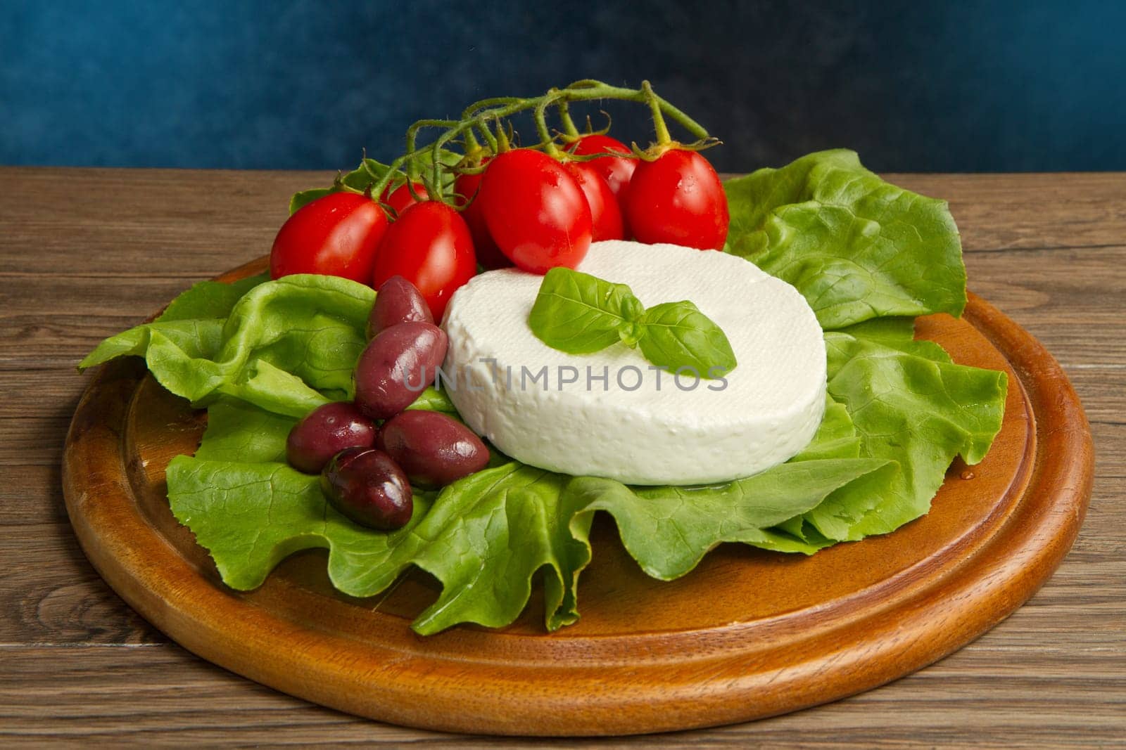 fresh cheese with salad, tomatoes and black olives