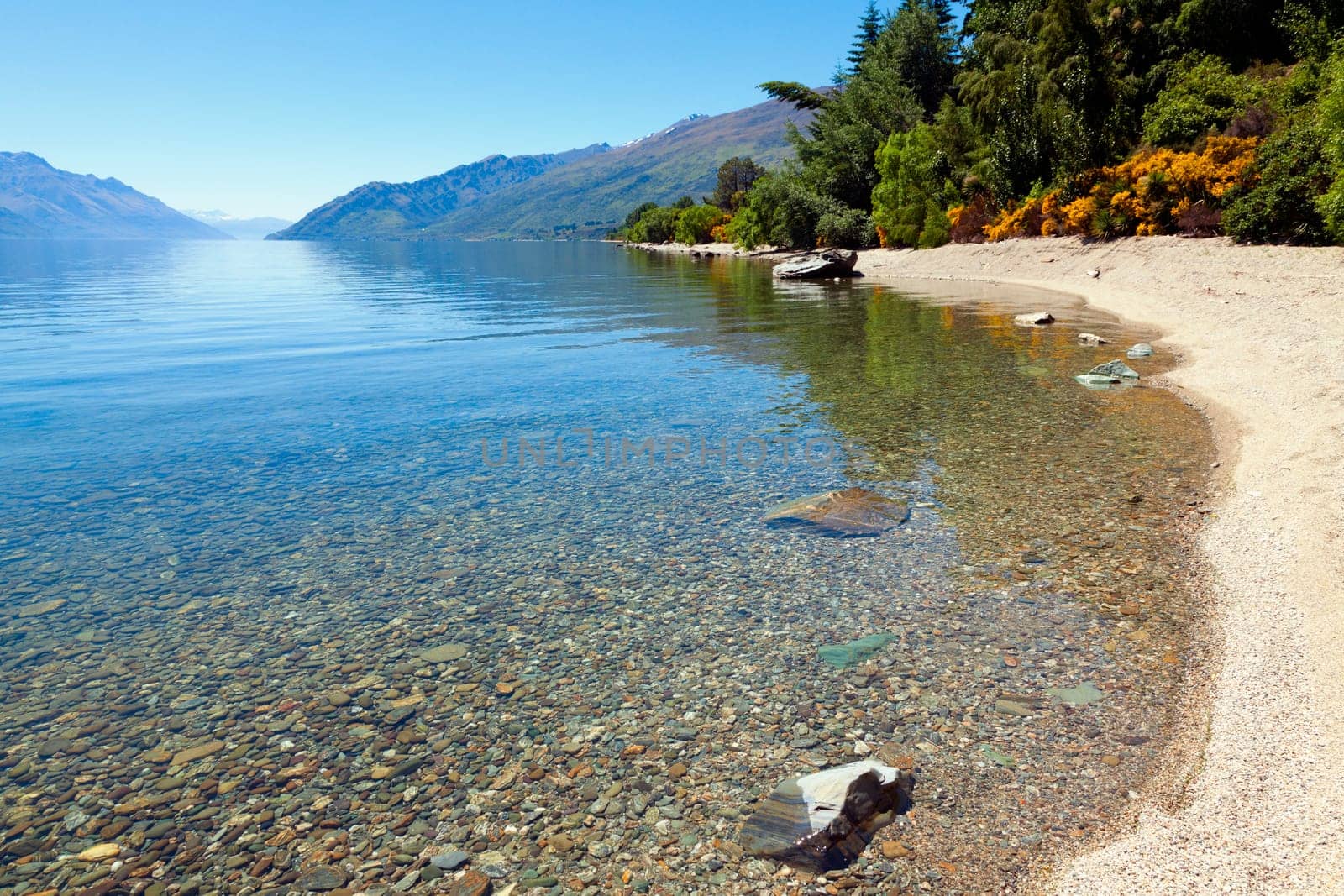 View of the clear waters and mountains at lake Wakatipu, New Zealand