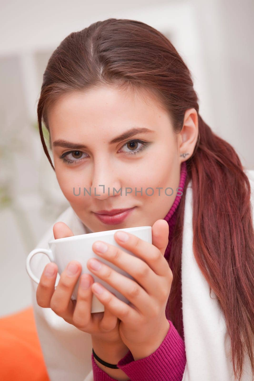 young woman with cup tea relaxed at home