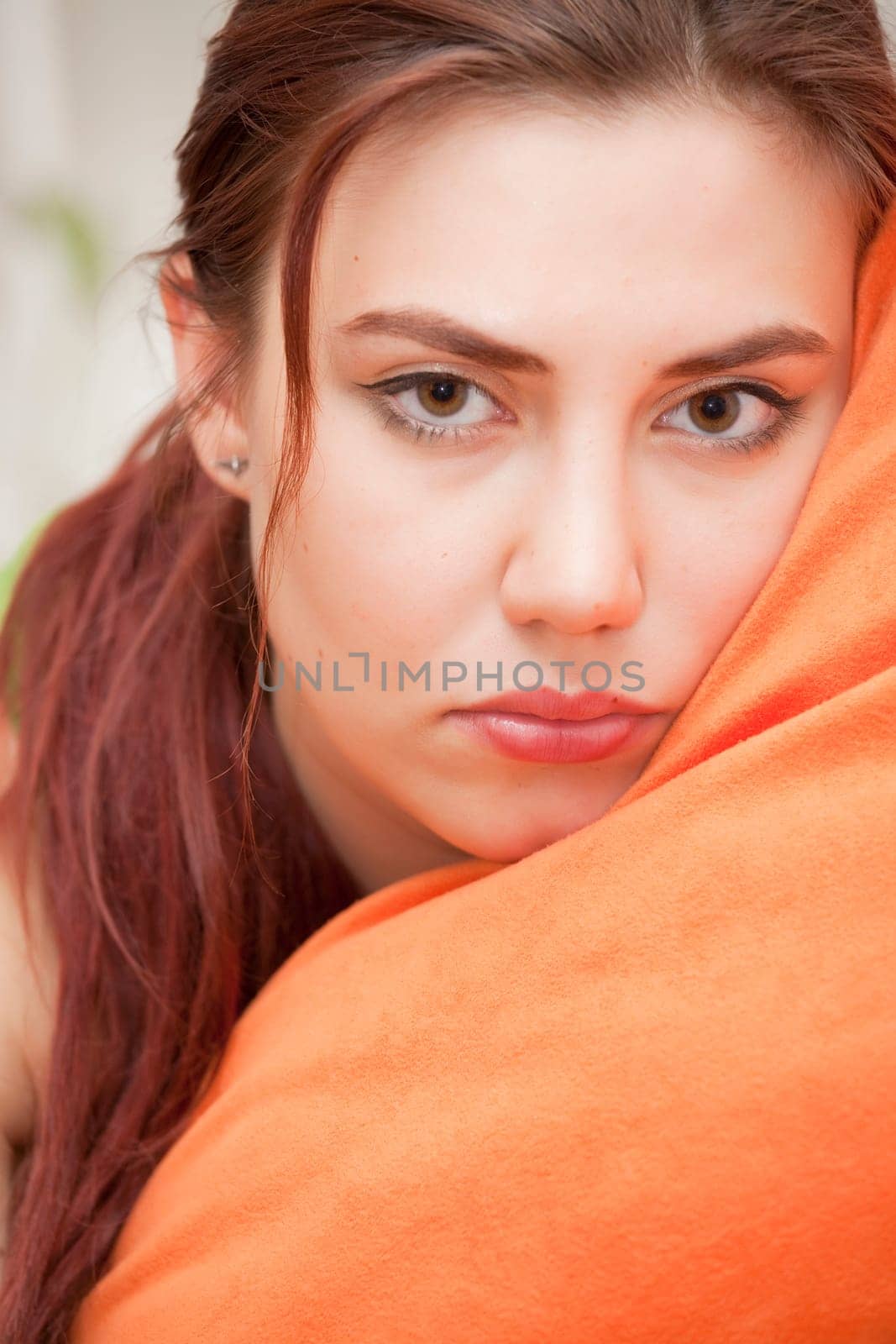 close up portrait of sad woman with pillow
