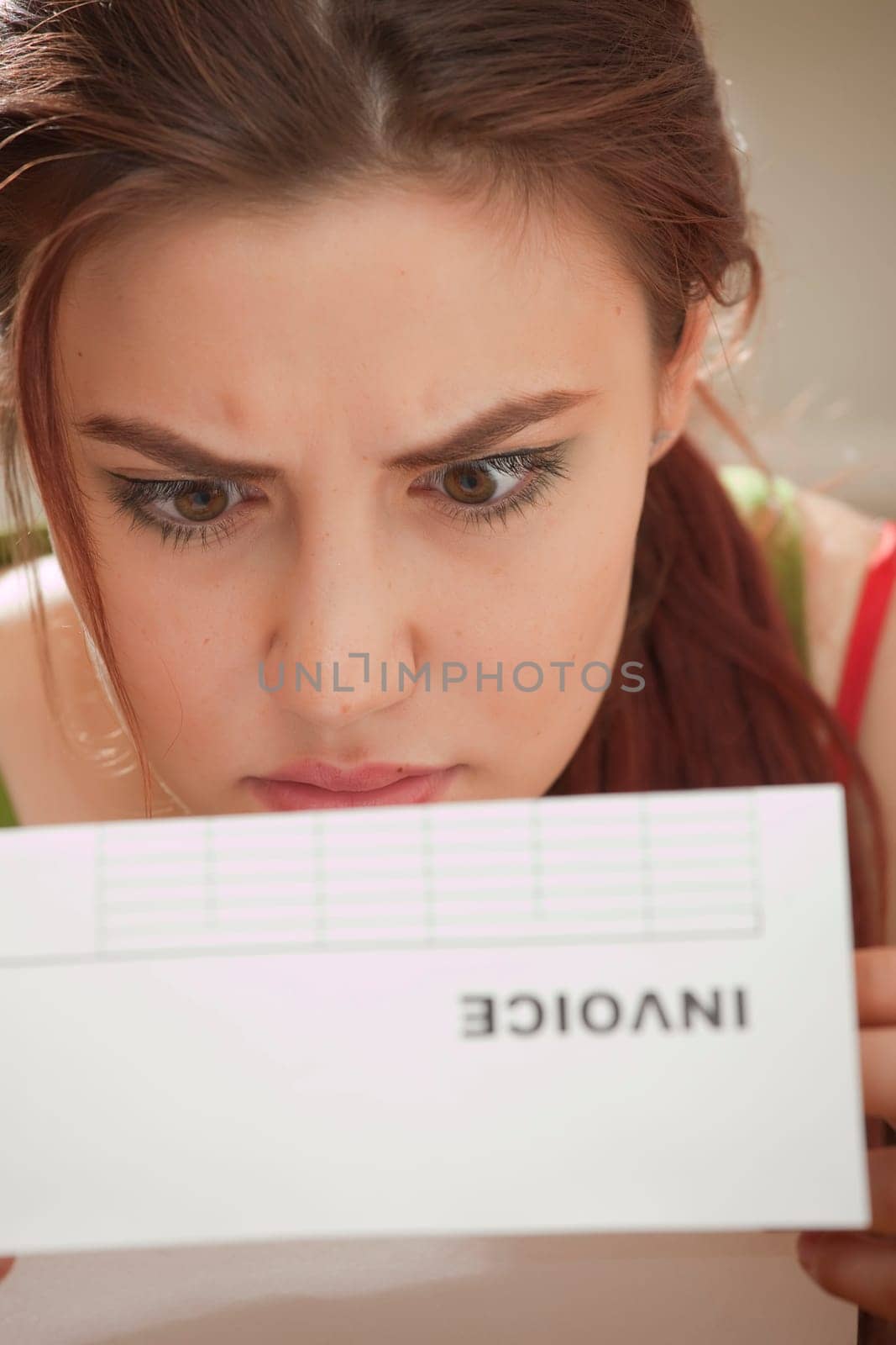 shocked woman looking at bill amount letter
