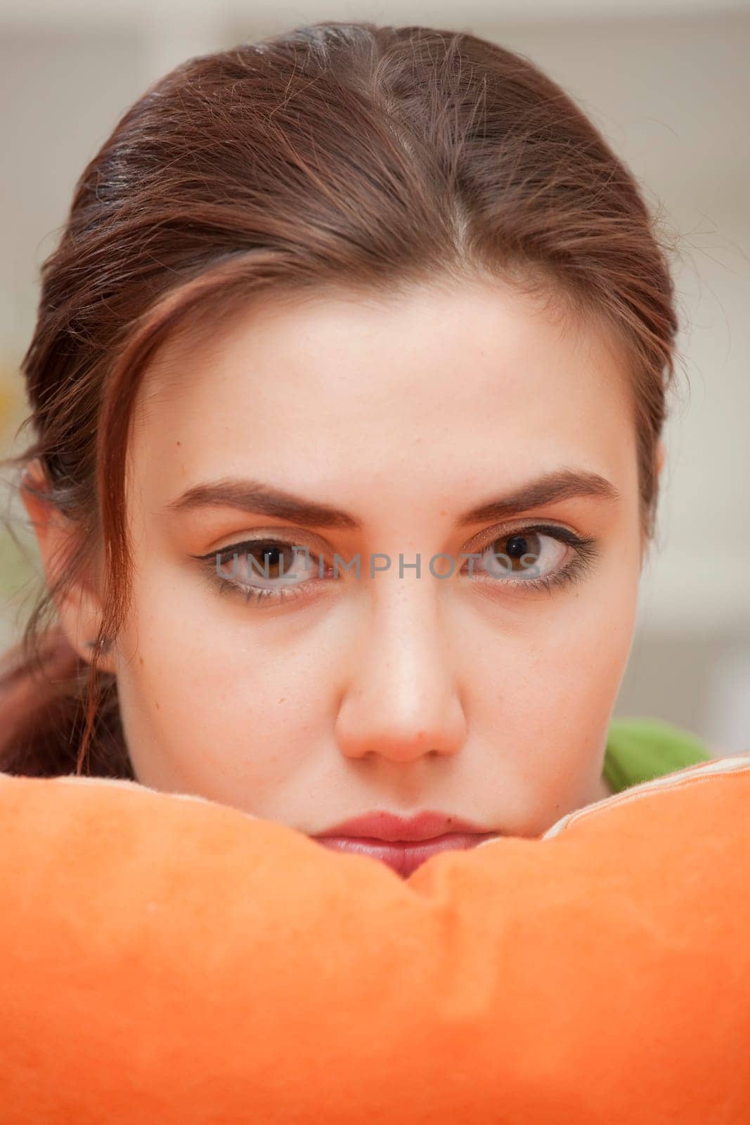 close up portrait of sad woman resting on pillow