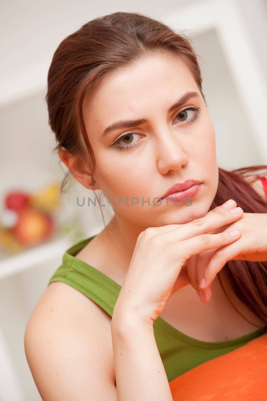 sad and depressed woman sitting on sofa at home